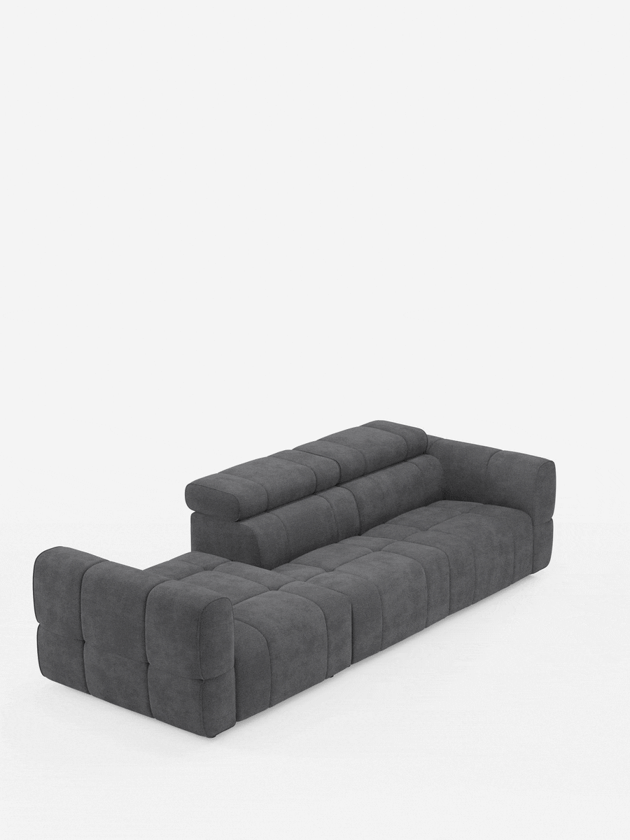 Il divano componibile Giotto con terminale aperto - opzione relax elettrico in tessuto smacchiabile T23 è un divano componibile grigio antracite dal design squadrato con trapuntatura a griglia e un terminale aperto sul lato sinistro, su sfondo bianco.
