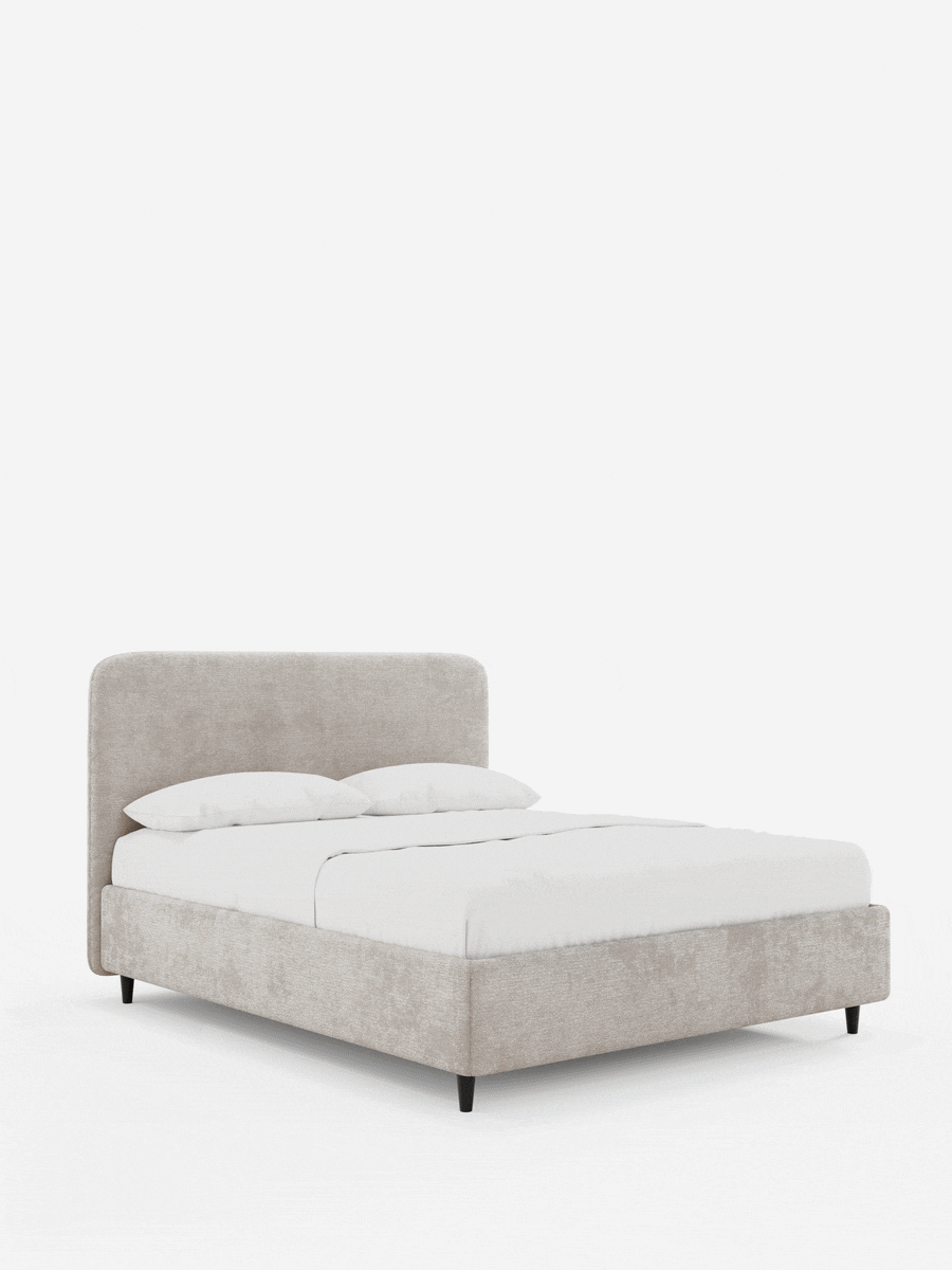 Il letto KAELOS minimal imbottito – con contenitore, gambe alte e testiera arrotondata in tessuto ciniglia – è un letto imbottito beige con testiera arrotondata e biancheria da letto bianca, che poggia su sottili gambe nere su uno sfondo bianco.