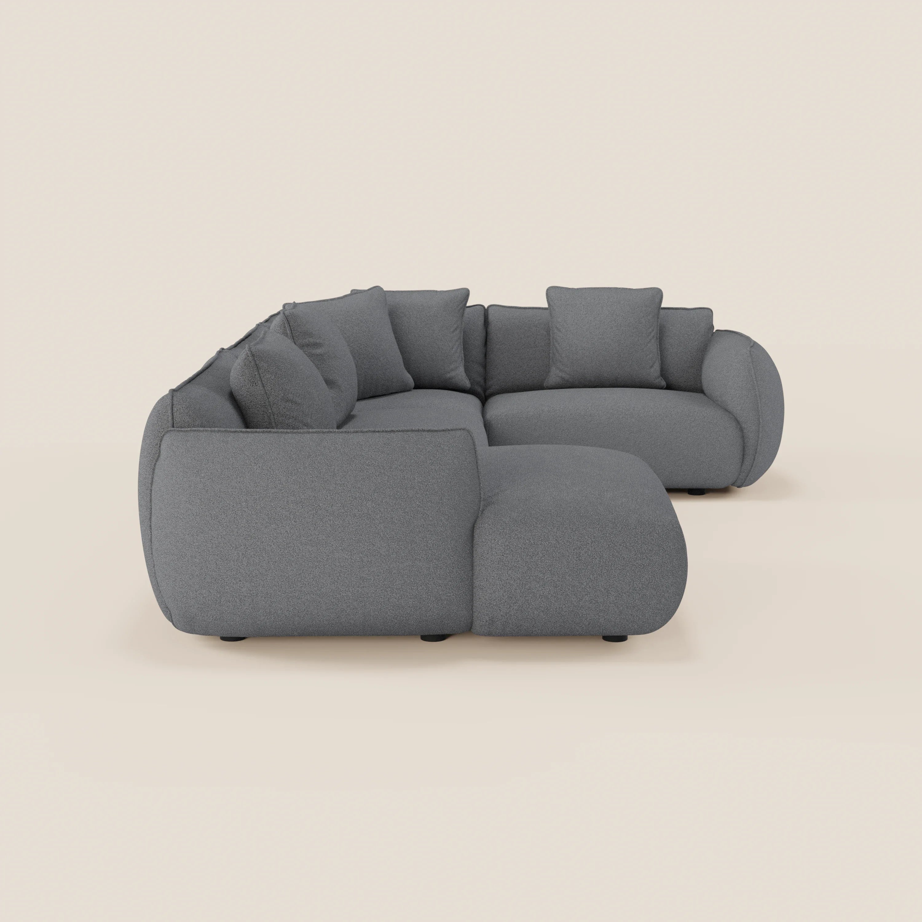 Il divano angolare panoramico componibile Nimbus di Divani.Store, in tessuto smacchiabile t33, presenta una moderna forma a L con cuscini in feltro, bordi arrotondati, piedini neri bassi e quattro cuscini sfusi. Prodotto in Italia.