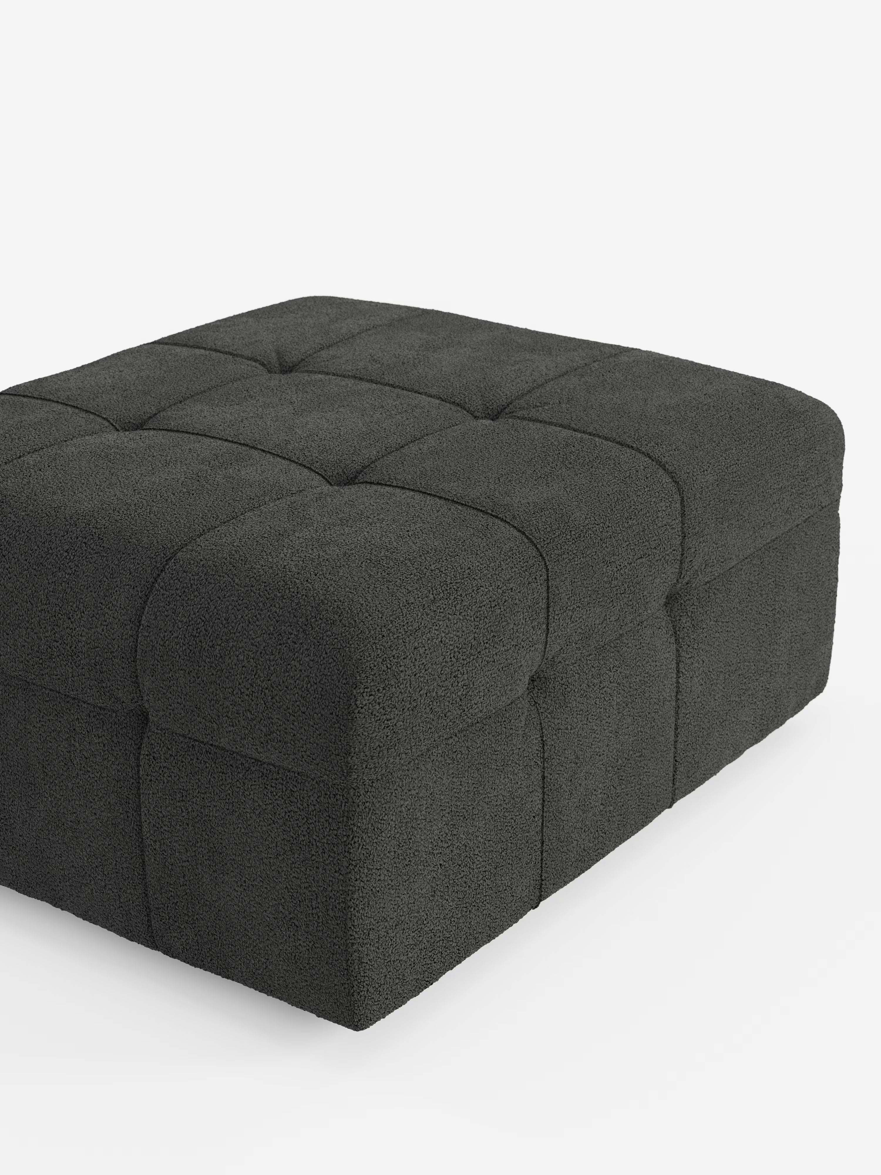 Un grande pouf quadrato “Mosaic” e modulo in bouclé di Divani.Store, che misura 96x77 cm ed è rivestito in tessuto T21 antimacchia, spicca su uno sfondo bianco. Ispirato al raffinato design capitonné, questo pouf presenta una profonda trapuntatura quadrata sulla parte superiore e sui lati, che gli conferisce un aspetto morbido e imbottito con linee pulite e moderne.