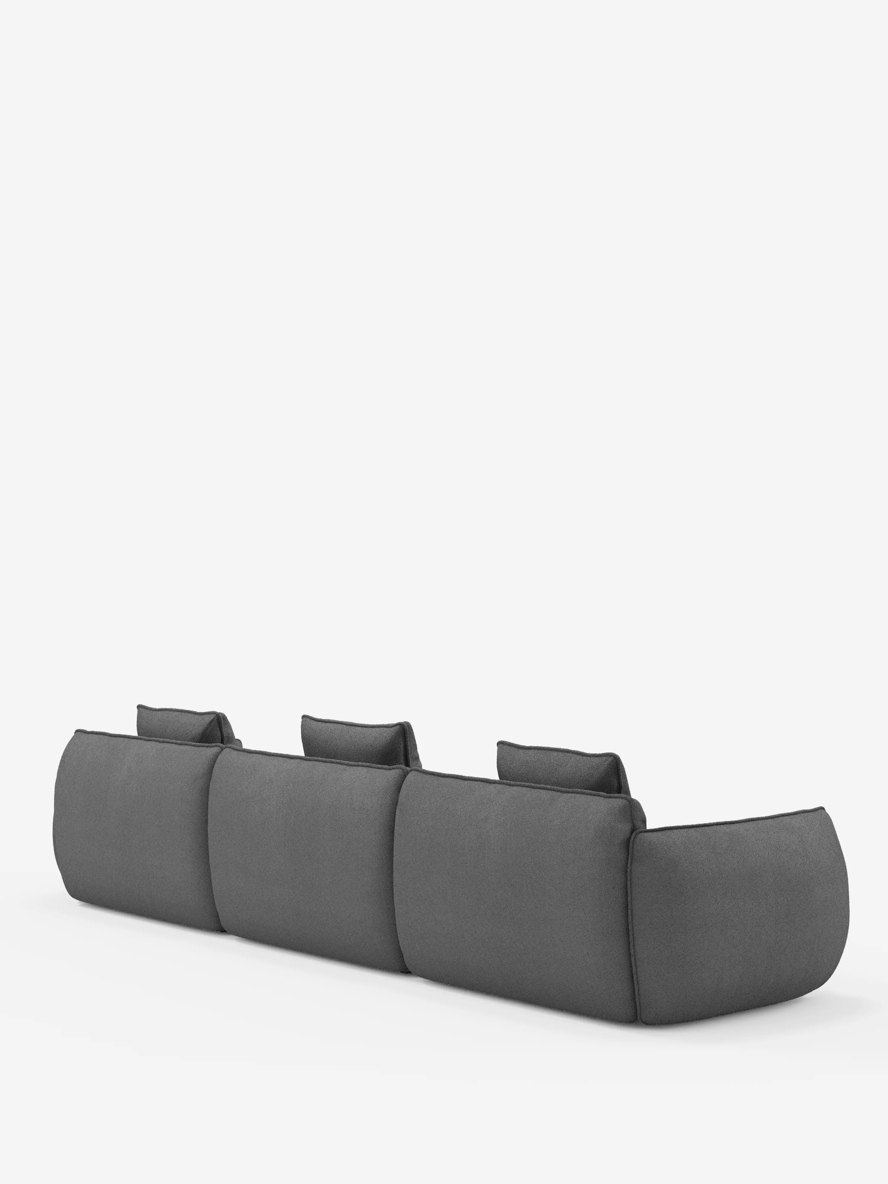 Il divano modulare Nimbus, un modello minimalista e moderno a 3 posti di Divani.Store, in grigio scuro, è ripreso da dietro, mettendo in risalto i suoi tre grandi cuscini dello schienale ben imbottiti. I bordi lisci e arrotondati e il morbido tessuto T33 effetto cotone, resistente alle macchie, risaltano su uno sfondo bianco a tinta unita.
