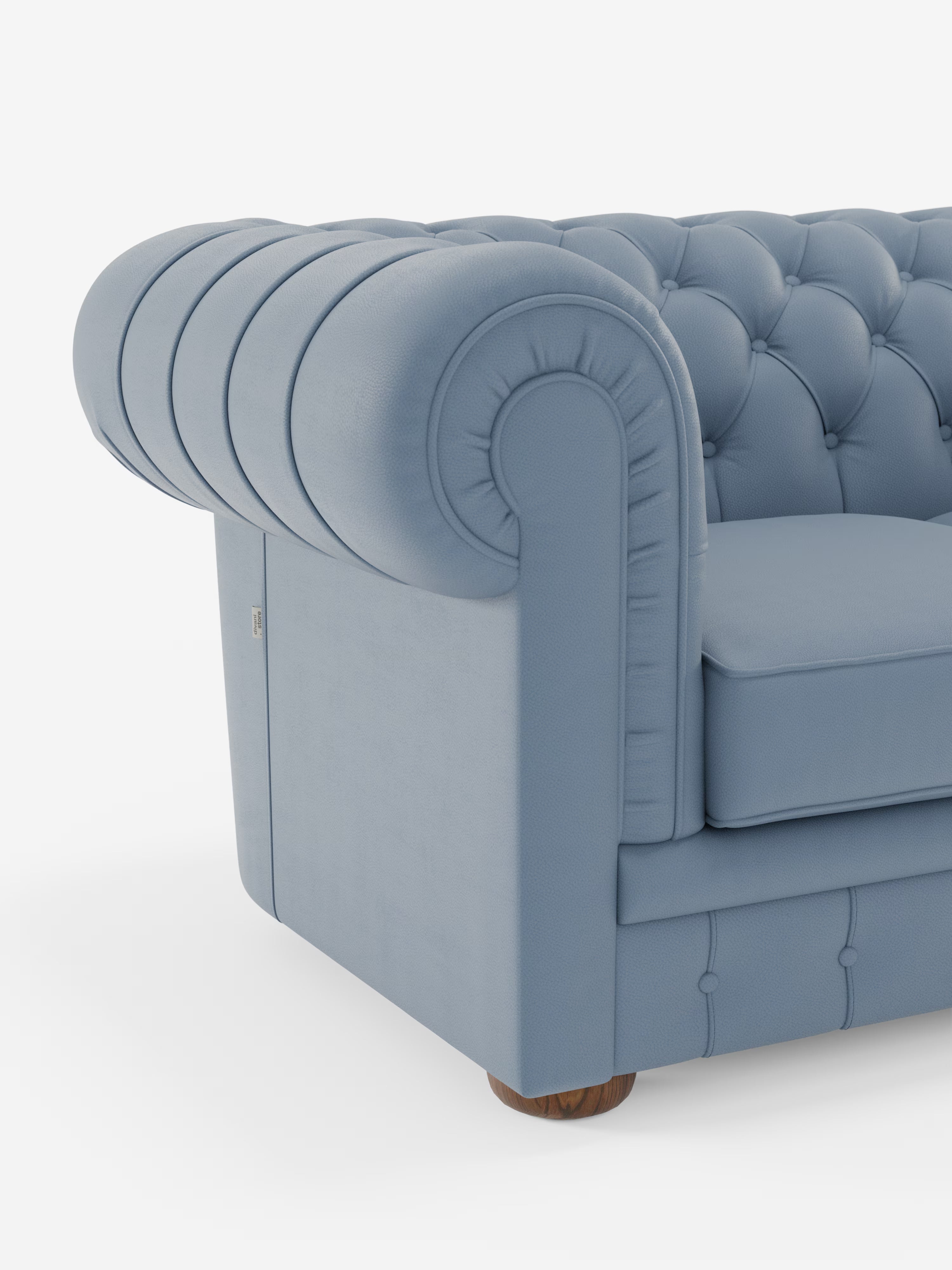 Un primo piano del divano Chester 4 Posti 3 sedute in Vera Pelle – Chesterfield Capitonné Artigianale di Divani.Store ne mette in risalto il lussuoso rivestimento capitonné, i braccioli arrotondati e i piedini in legno. Realizzato con maestria artigianale in Italia, questo divano presenta un design classico ed elegante, caratterizzato da morbida vera pelle e cuciture curate nei dettagli, che risaltano sullo sfondo bianco a tinta unita.