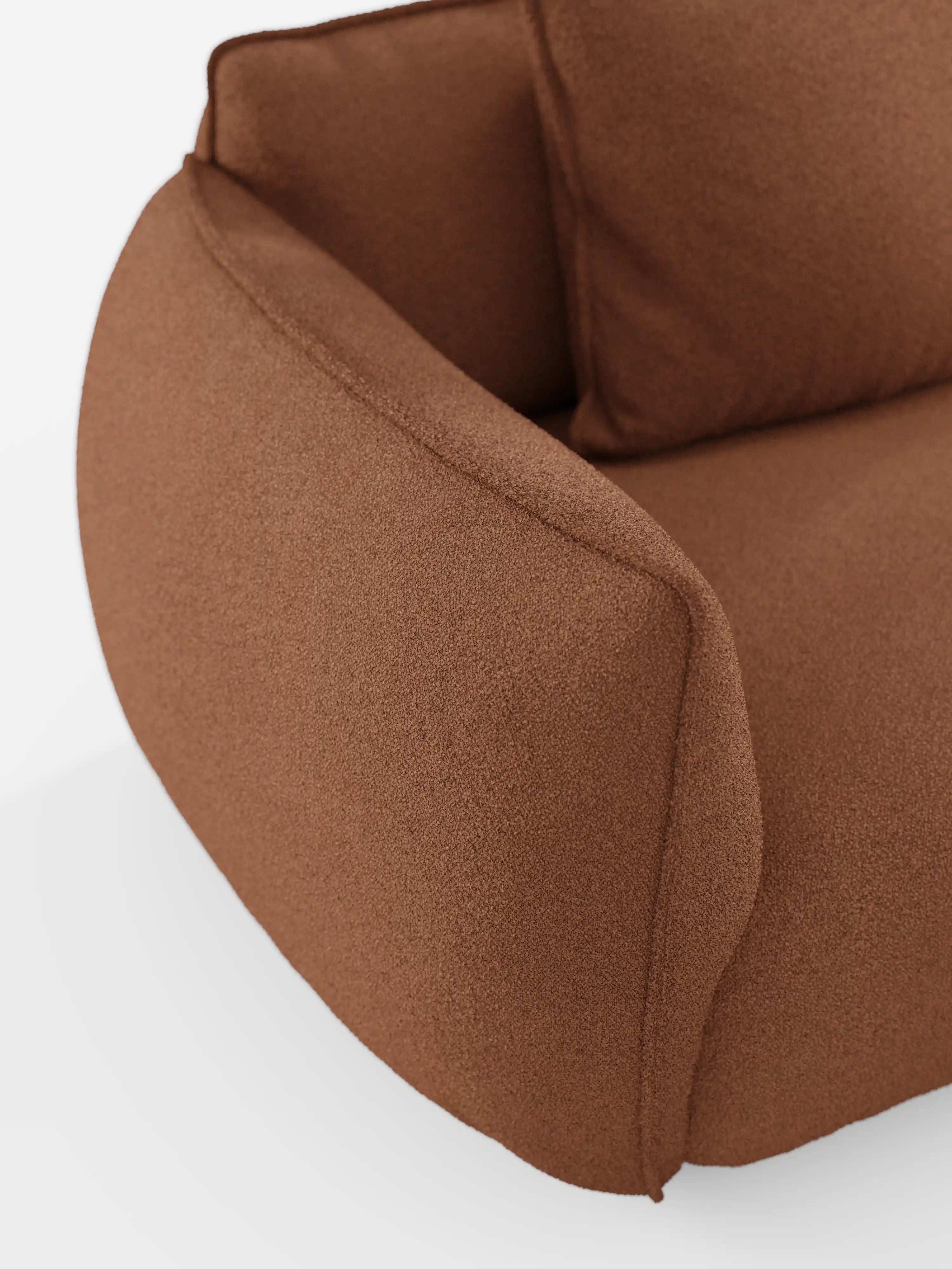Un primo piano del divano modulare a 3 posti Nimbus, realizzabile in morbido tessuto smacchiabile effetto cotone T33 di Divani.Store, mette in risalto il suo rivestimento moderno color marrone con braccioli arrotondati e un tessuto morbido e strutturato. L’attenzione rivolta ai braccioli e alla seduta mette in risalto il design elegantemente sinuoso della poltrona e l’imbottitura soffice — caratteristiche distintive dei divani componibili di alta gamma — su uno sfondo bianco pulito.