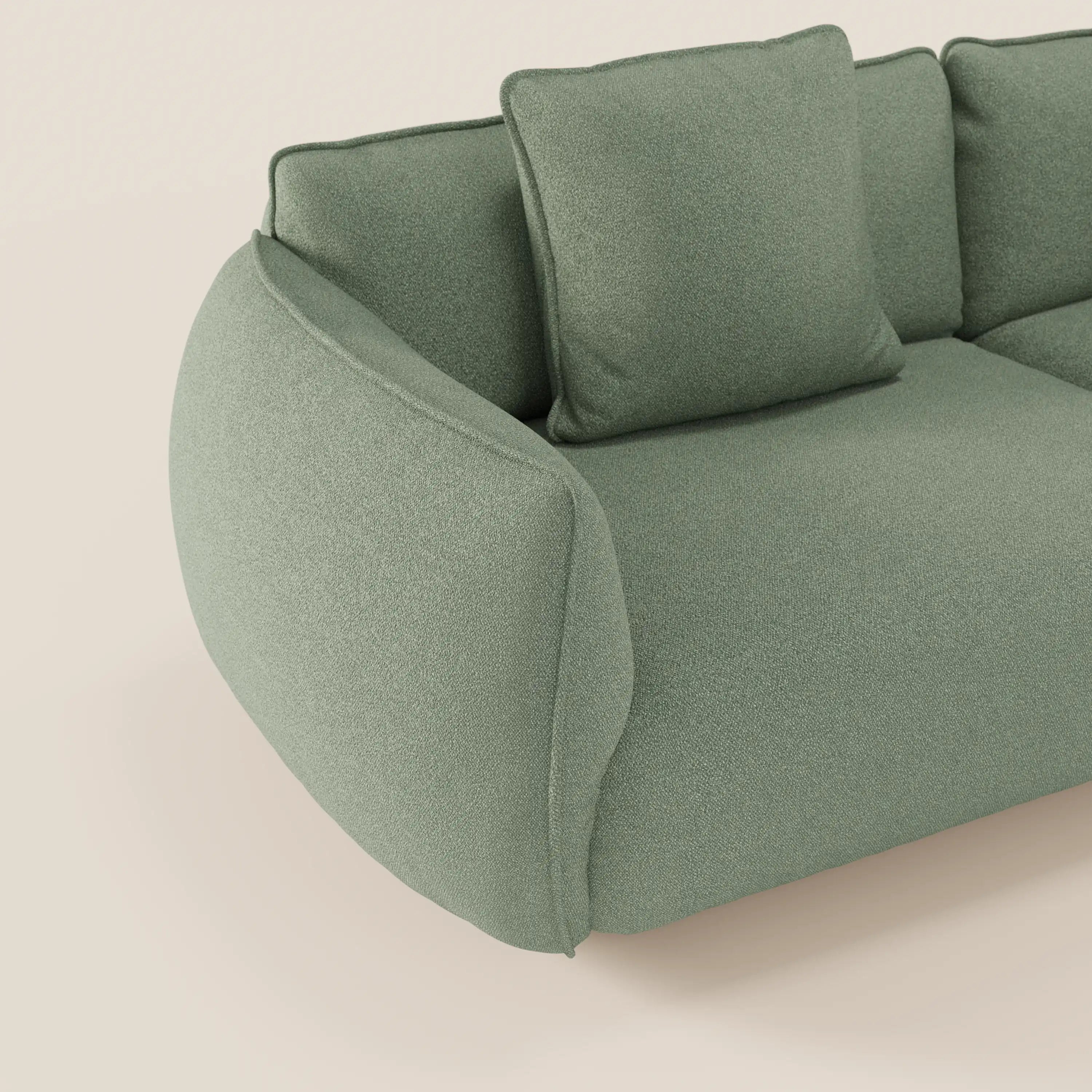 Il divano Nimbus modulare a 3 sedute componibile di Divani.Store è mostrato in tessuto smacchiabile effetto cotone T33, verde salvia chiaro, con braccioli e schienale arrotondati, cuscini morbidi e sfoderabili, su sfondo beige.