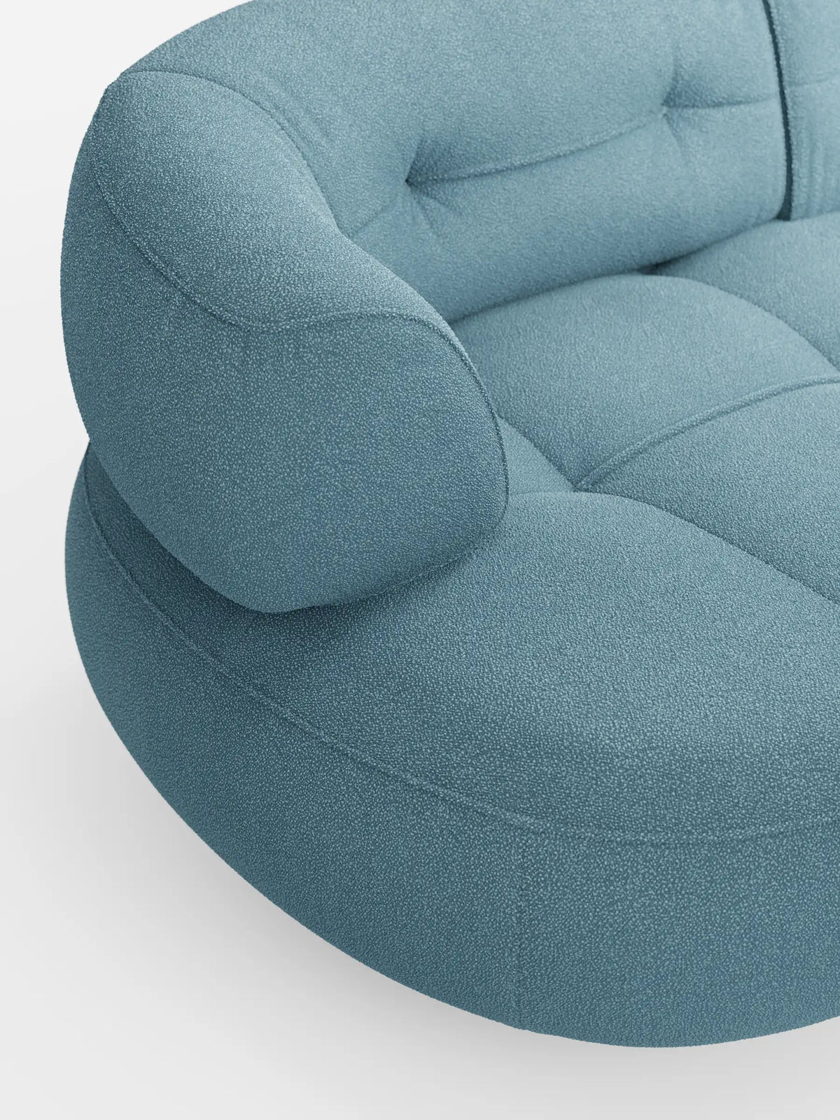 Un primo piano di un divano curvo “Croissant” a fagiolo a 3 posti, di colore azzurro chiaro, con schienali traslanti, rivestito in morbido tessuto effetto cotone smacchiabile T33, caratterizzato da una finitura testurizzata, seduta trapuntata e morbidi braccioli su uno sfondo bianco a tinta unita.