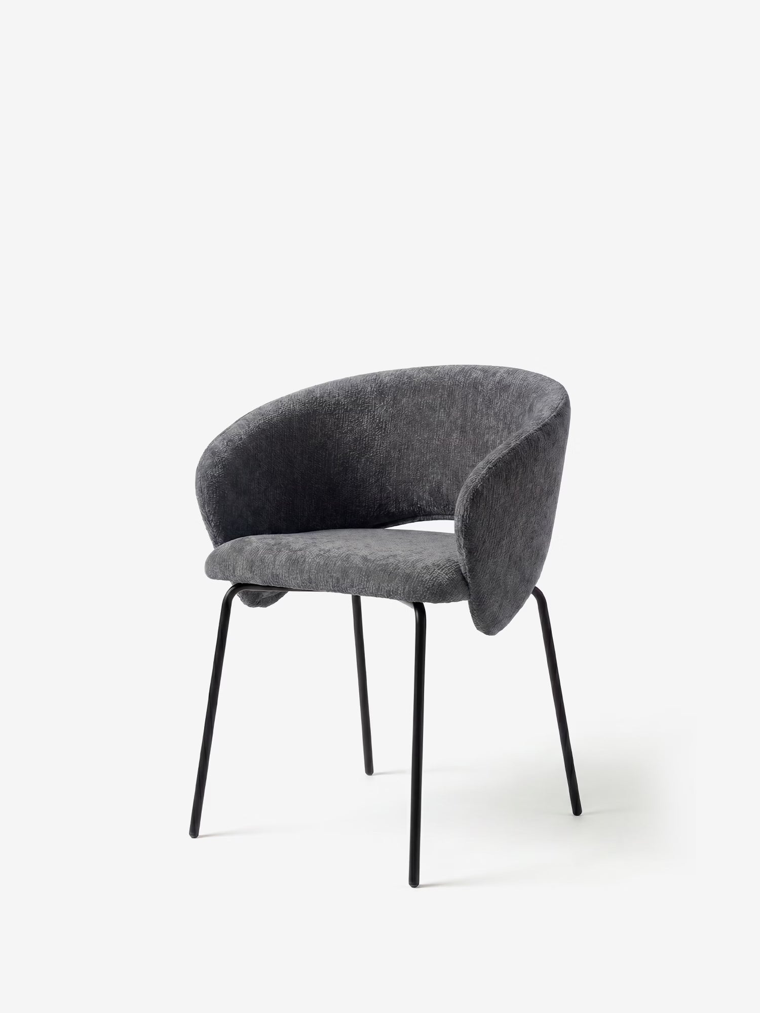 La sedia imbottita Fosca di Divani.Store presenta un design minimalista e contemporaneo con braccioli, uno schienale imbottito e curvo, rivestimento in tessuto grigio scuro certificato OEKO-TEX® e gambe in metallo nero inclinate verso l’esterno.