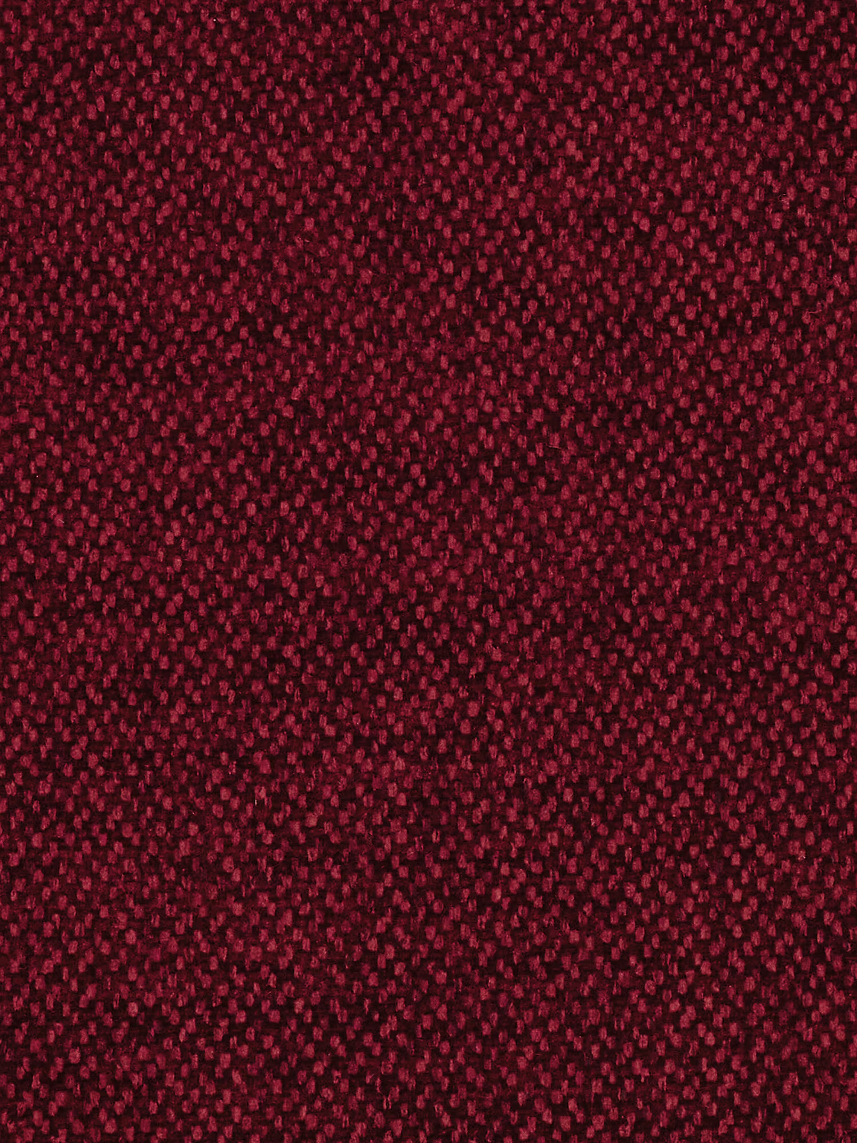 Un primo piano del tessuto ruvido, di un rosso intenso, utilizzato per il divano Doric a 3 posti con sedute allungabili tramite meccanismo relax elettrico di Divani.Store rivela un fitto motivo di minuscoli puntini irregolari in diverse tonalità di rosso. Questo aspetto delicato e screziato ricopre l’intera superficie, rendendolo una scelta ideale per un design sofisticato del divano o come complemento perfetto al poggiatesta reclinabile del Doric e al rivestimento T23 di facile pulizia.