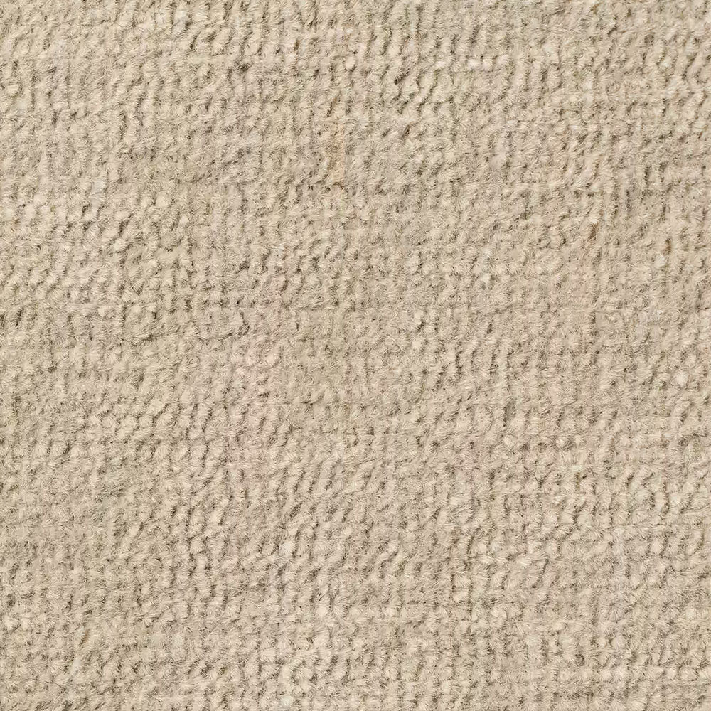 Primo piano di Personalizzazione in T31 di Divani.Store: un tappeto beige con piccole asole in rilievo per un aspetto morbido e soffice. La tonalità neutra presenta sottili variazioni di colore dovute alla trama della fibra.