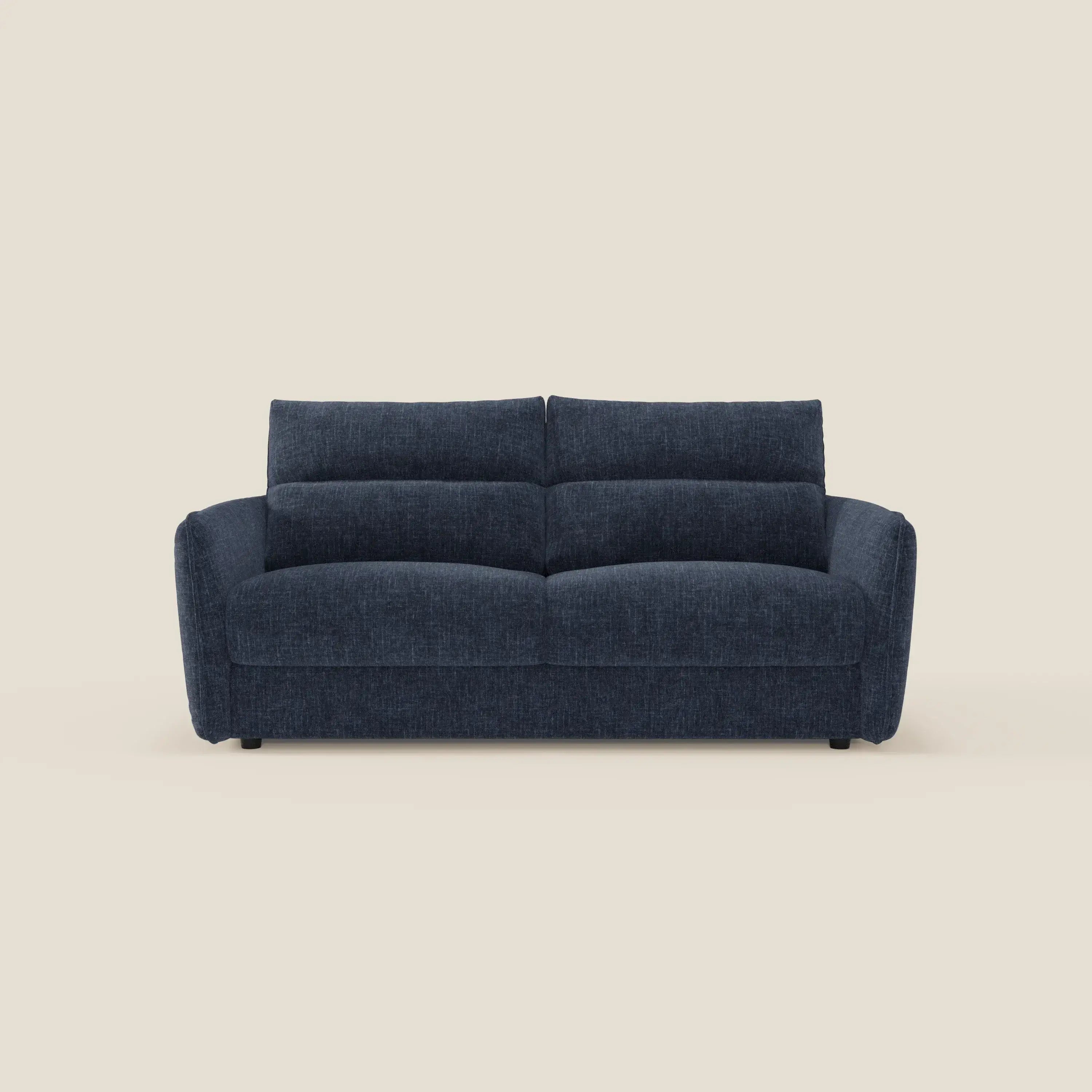 Elios Divano letto di Divani.Store è un divano contemporaneo di colore blu notte, con cuscini di schienale in peluche e ampi braccioli in tessuto smacchiabile T24. Ha tre posti a sedere ed è caratterizzato da un design minimalista, presentato su uno sfondo bianco sporco.