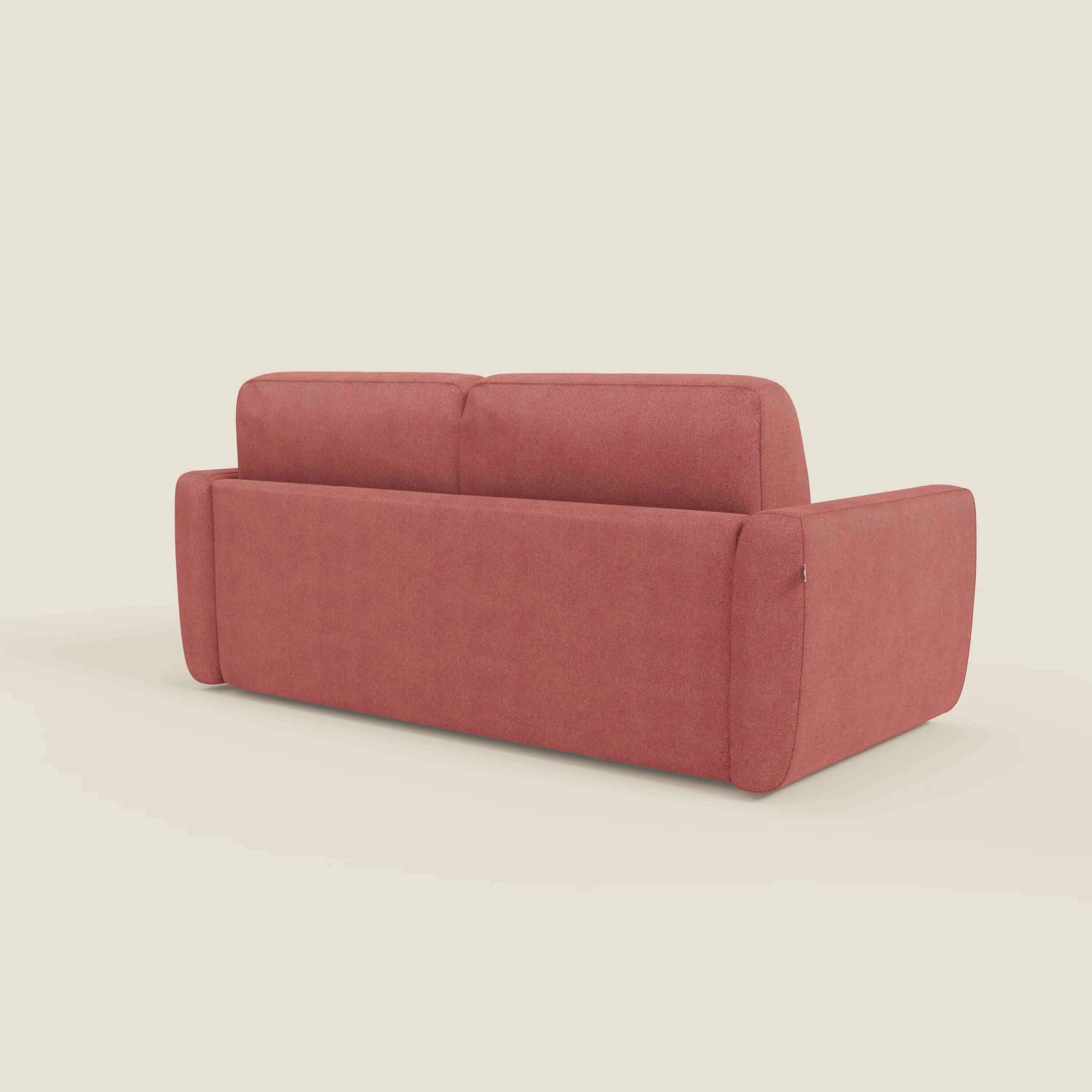 Il divano letto sfoderabile Leonida di Divani.Store in smacchiabile T23 rosso ciliegia è caratterizzato da un design squadrato, ampi braccioli, due cuscini di schienale, un materasso ad alta densità H18 cm e un vano portaguanciali, il tutto rappresentato dallo schienale su sfondo beige.