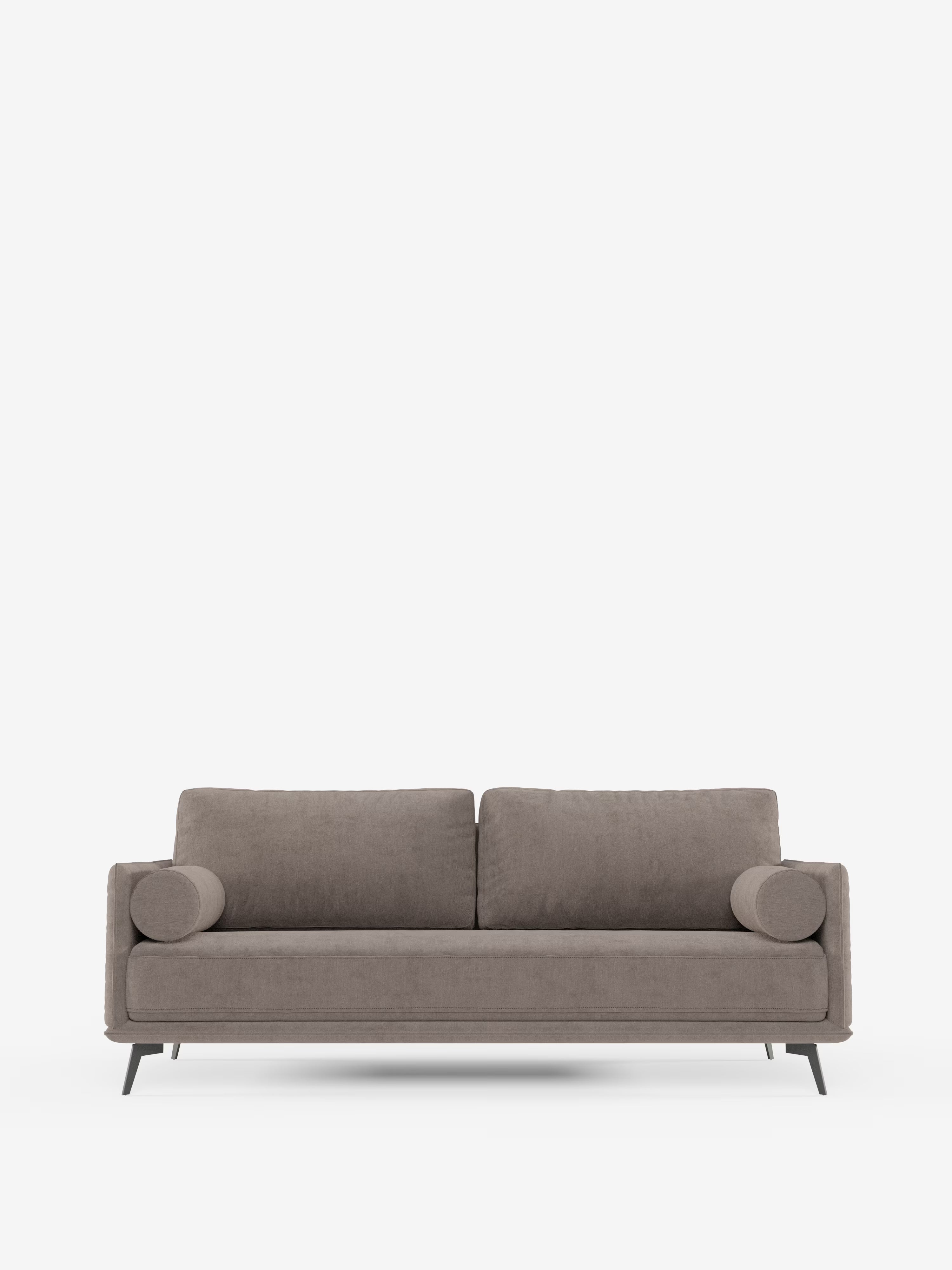 Vi presentiamo il divano lineare Basalto a 2 o 3 posti di Divani.Store: un moderno divano color taupe caratterizzato da un esclusivo cuscino di seduta singolo e da una base in metallo. Questo elegante divano minimalista presenta linee pulite, braccioli bassi e quattro gambe sottili e angolate in metallo nero. Rivestito in tessuto smacchiabile T31, coniuga con disinvoltura stile e praticità su uno sfondo bianco a tinta unita.