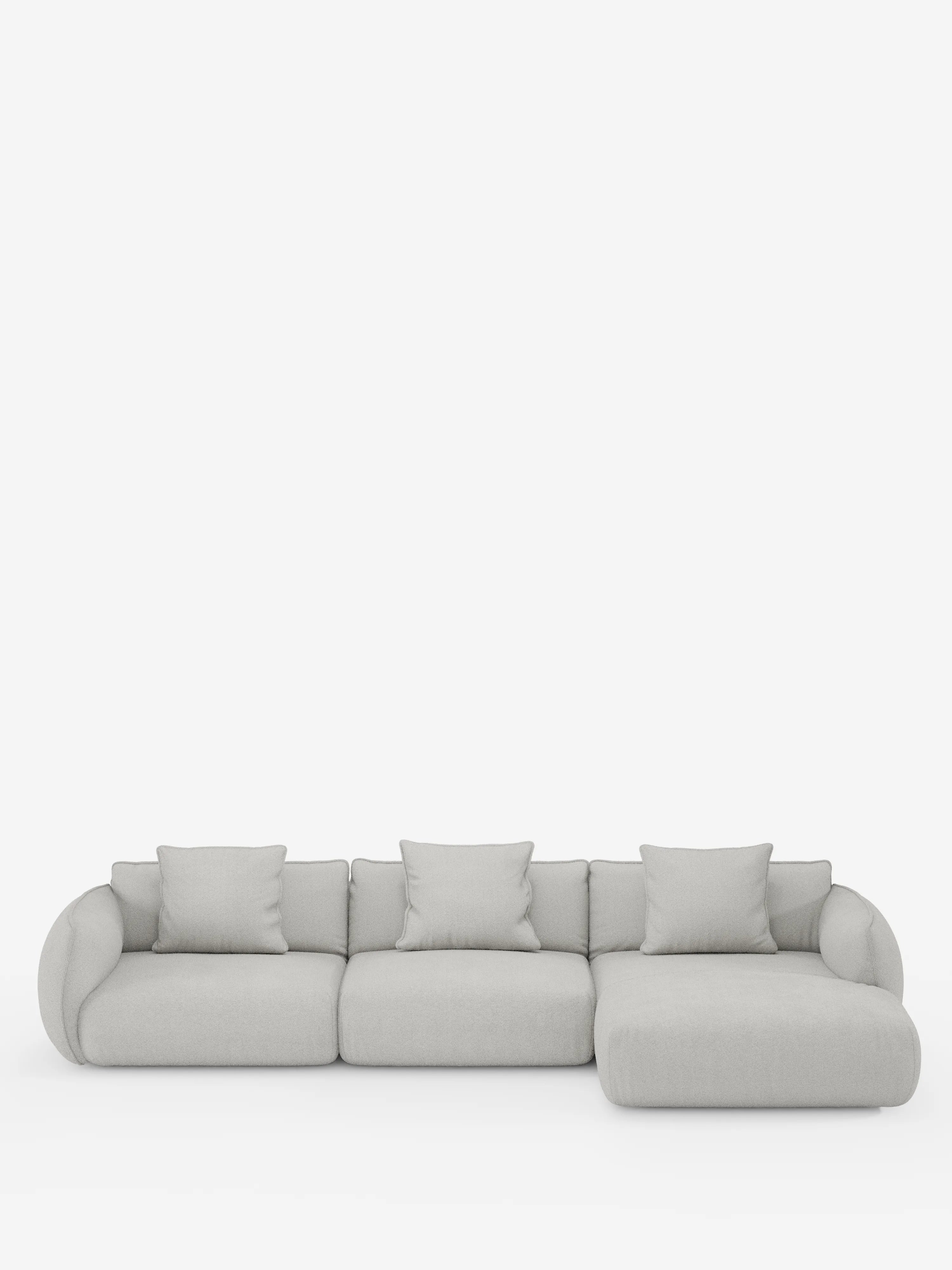 Vi presentiamo il divano angolare con penisola componibile Nimbus in morbido tessuto effetto cotone smacchiabile T33 di Divani.Store: un divano componibile moderno, di colore grigio chiaro, composto da tre cuscini di seduta, una chaise longue sul lato destro e quattro cuscini quadrati coordinati. Questo divano moderno in stile contemporaneo vanta braccioli arrotondati e un design minimalista, messo in risalto da uno sfondo bianco a tinta unita.