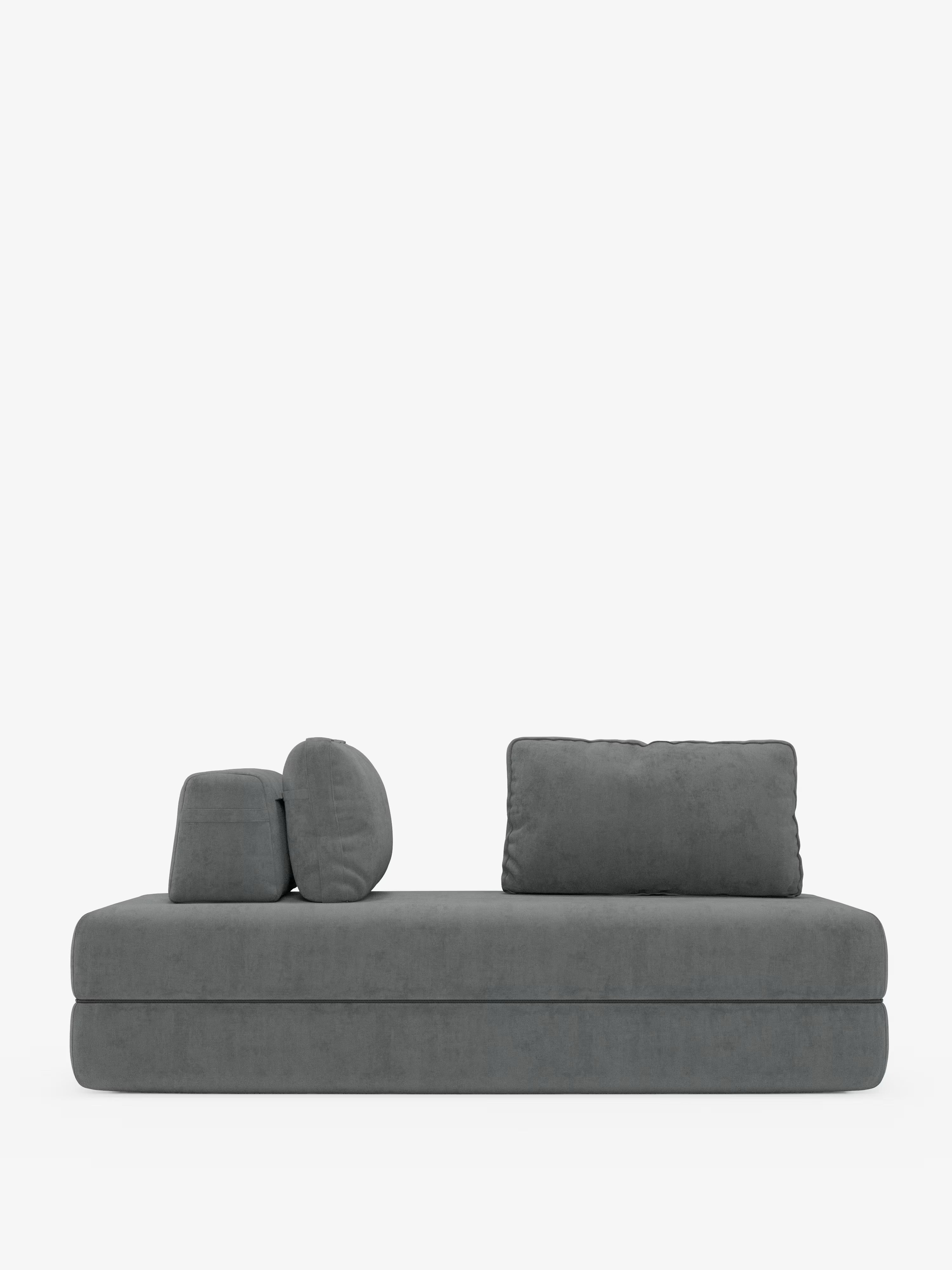 Un divano letto matrimoniale Rift moderno e minimalista di colore grigio, disponibile su Divani.Store, dotato di due o tre posti con schienali regolabili, tre cuscini rimovibili — due rotondi e uno rettangolare — e un materasso in memory foam dello spessore di 24 cm rivestito in tessuto T31 facile da pulire. Su uno sfondo bianco a tinta unita, il suo profilo basso e squadrato e le linee pulite lo rendono l’elemento perfetto per qualsiasi ambiente contemporaneo.