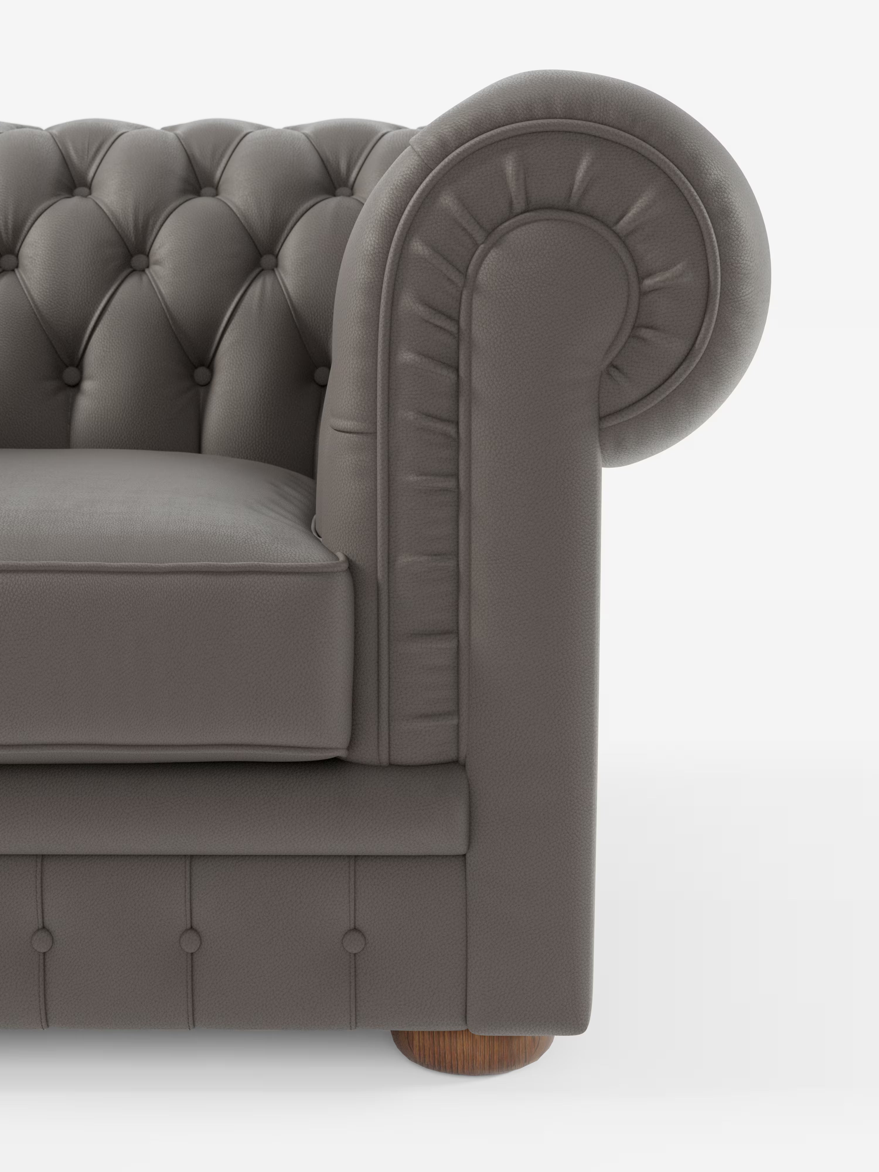 Primo piano del bracciolo destro della poltrona Chester in vera pelle spessorata con capitonné artigianale di Divani.Store, che mette in risalto il rivestimento in pelle grigia trapuntata, il bracciolo arrotondato con dettagli cuciti e la gamba rotonda in legno. Ispirato al classico design Chester, il morbido cuscino è messo in risalto su uno sfondo bianco a tinta unita, con solo una parte della seduta e dello schienale visibile.