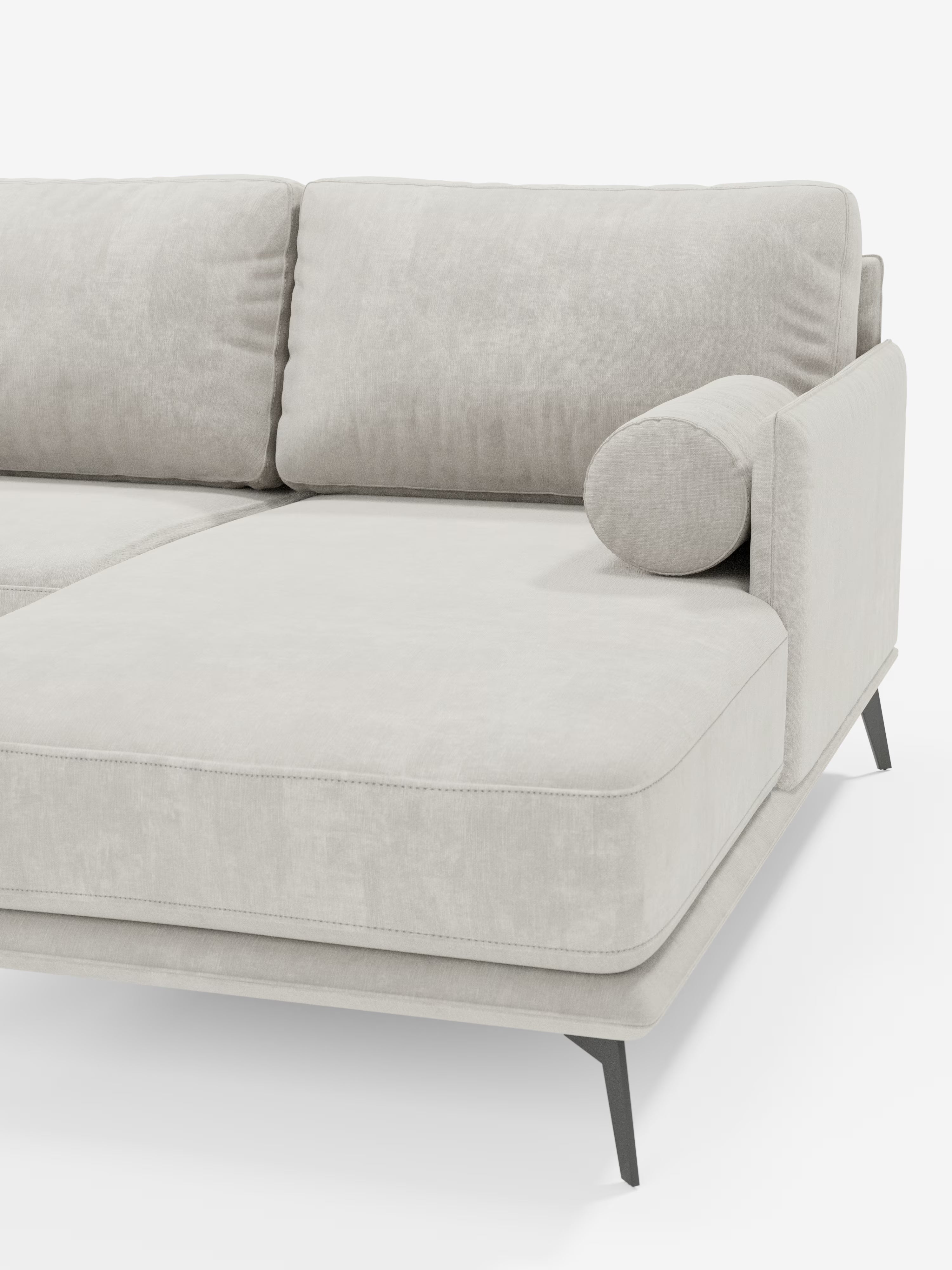 Un divano angolare contemporaneo Basalto con penisola di Divani.Store, rivestito in morbido tessuto testurizzato T31 di facile manutenzione, con soffici cuscini in piuma e un cuscino cilindrico. L'elegante base in metallo nero presenta gambe angolate. È visibile solo una parte del divano, che comprende il bracciolo e la sezione chaise longue.
