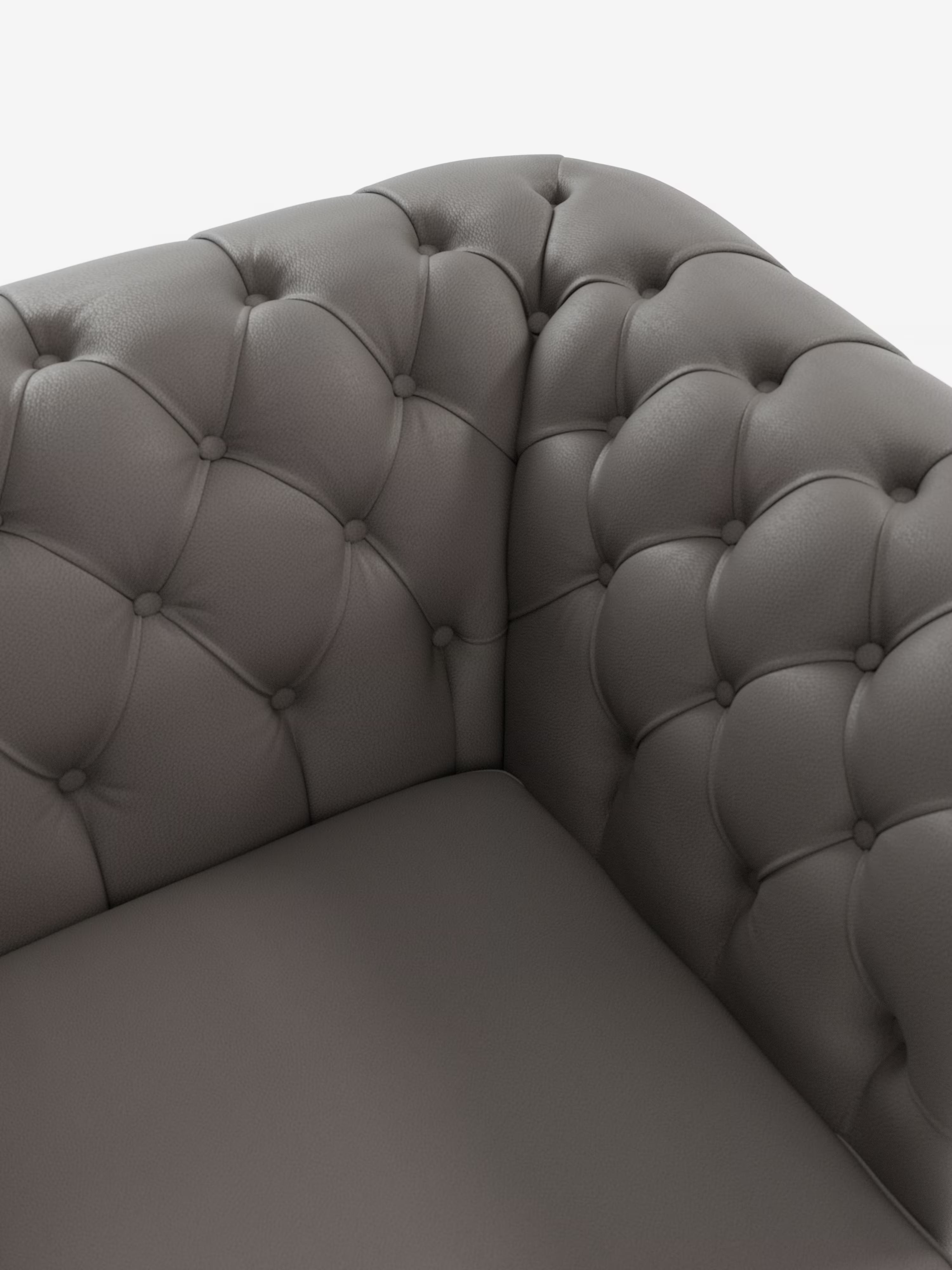 Primo piano dell'angolo del divano Chester 4 Posti 3 sedute in Vera Pelle – Chesterfield Capitonné Artigianale di Divani.Store. Il divano grigio scuro presenta una profonda trapuntatura a bottoni lungo lo schienale e i braccioli, che crea un motivo trapuntato e lussuoso, caratteristico del classico design Chesterfield. La vera pelle appare liscia, con la luce che ne accentua la morbida consistenza e la struttura soffice, a testimonianza della sua lavorazione artigianale.