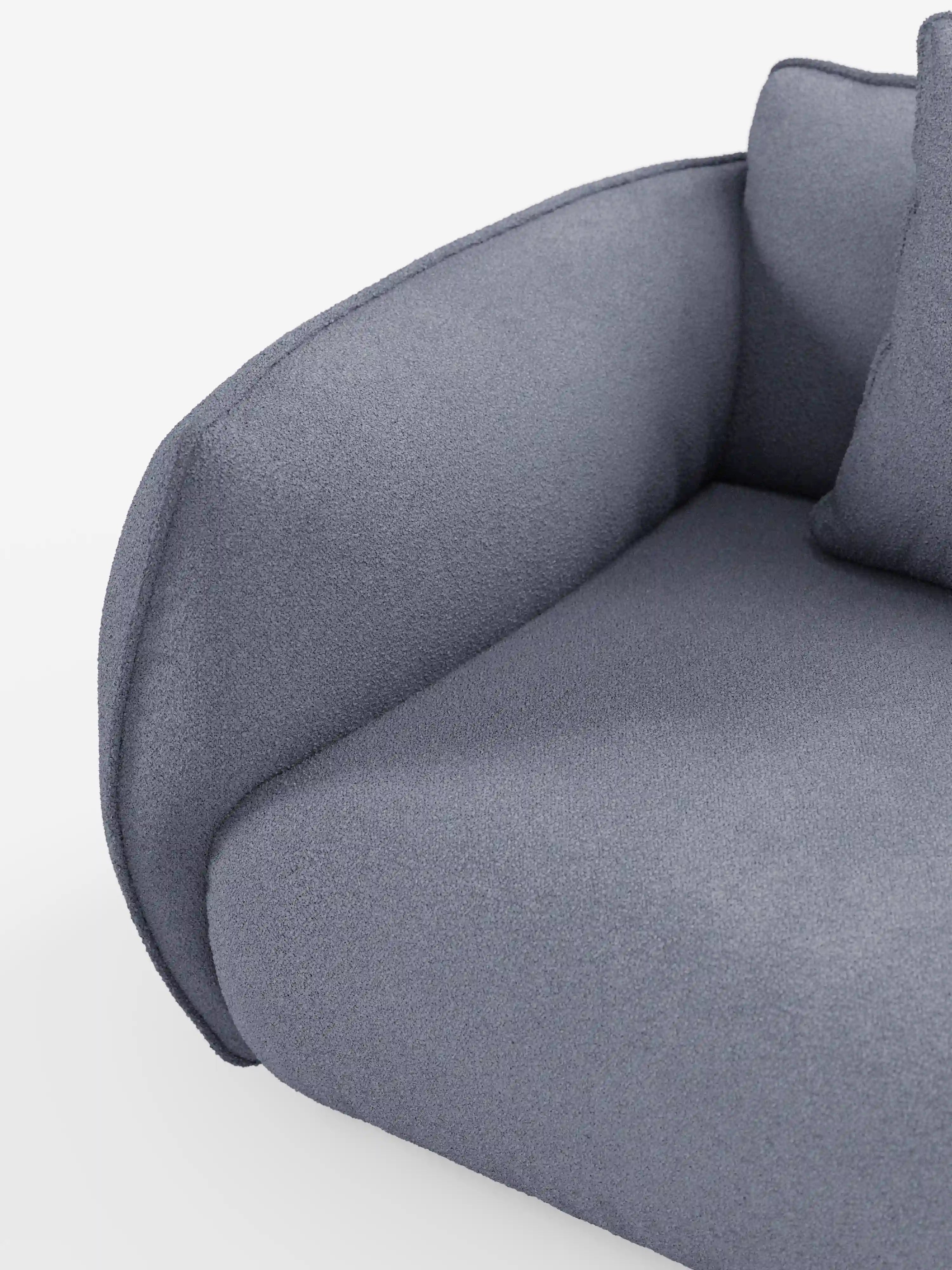 Primo piano del divano modulare a 3 posti Nimbus di Divani.Store, caratterizzato da un bracciolo rivestito in morbido tessuto T33 effetto cotone, resistente alle macchie. Il cuscino e lo schienale, morbidi e dalla forma arrotondata, presentano bordi puliti e arrotondati. Questo divano modulare risalta sullo sfondo bianco, mettendo in risalto il suo design lineare e contemporaneo.
