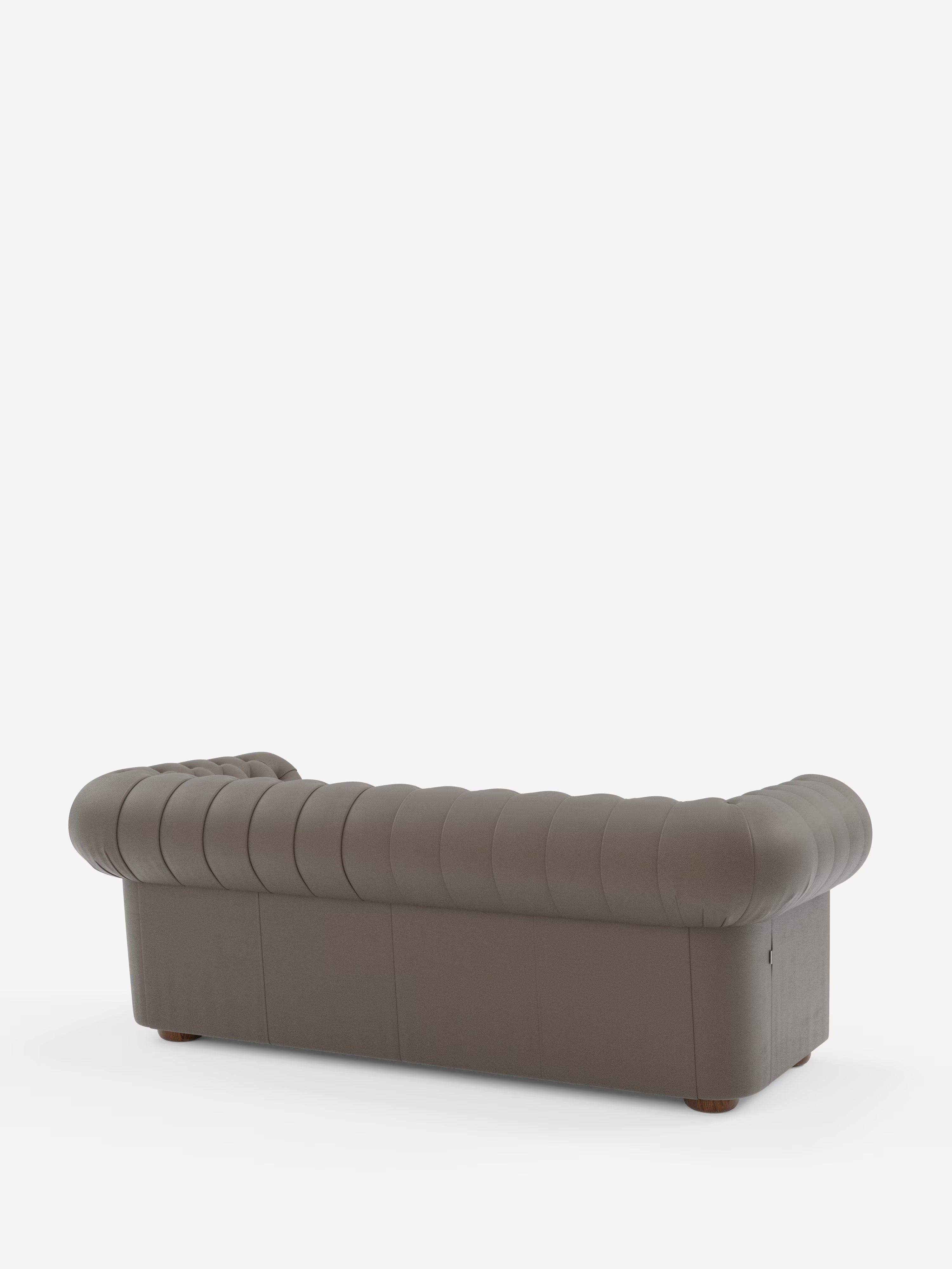 Un Chesterfield marrone – Divano Chesterfield in vera pelle spessorata a 2 e 3 posti di Divani.Store, con dettagli a capitonné, braccioli e schienale arrotondati, è ripreso di retro su uno sfondo bianco a tinta unita. Questo elegante divano artigianale italiano presenta gambe corte in legno e un rivestimento in vera pelle morbida e soffice.