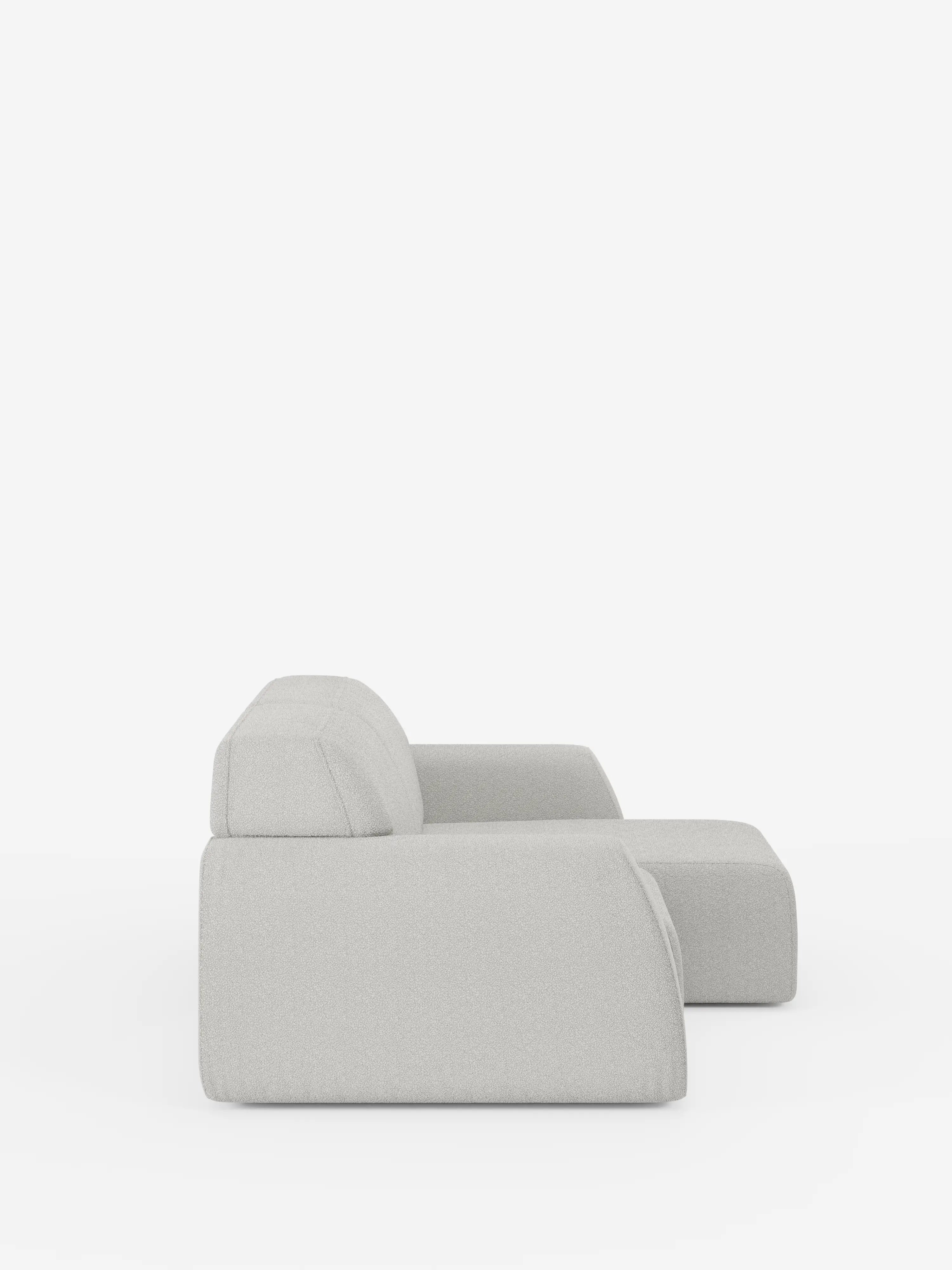 Il divano a 3 posti Orbit di Divani.Store è ripreso di profilo su uno sfondo bianco a tinta unita. Rivestito in tessuto T33 grigio chiaro, smacchiabile ed effetto cotone, questo divano con rivestimento completamente sfoderabile presenta uno schienale basso, ampi braccioli e un design contemporaneo, minimalista e squadrato, caratterizzato da linee morbide e pulite.