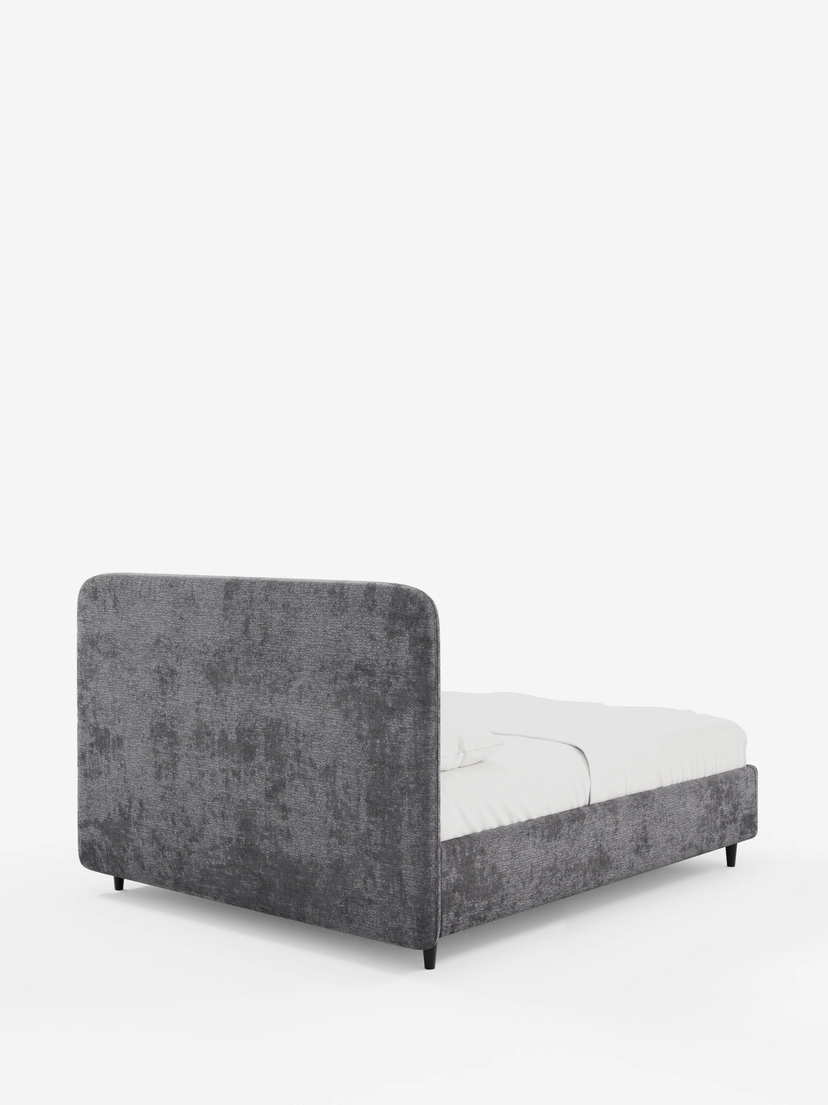 Il letto KAELOS minimal imbottito – con contenitore, gambe alte e testiera arrotondata in tessuto ciniglia – è un letto imbottito in stile minimal con testiera arrotondata in tessuto ciniglia grigio scuro a trama ruvida, gambe sottili nere e materasso bianco.