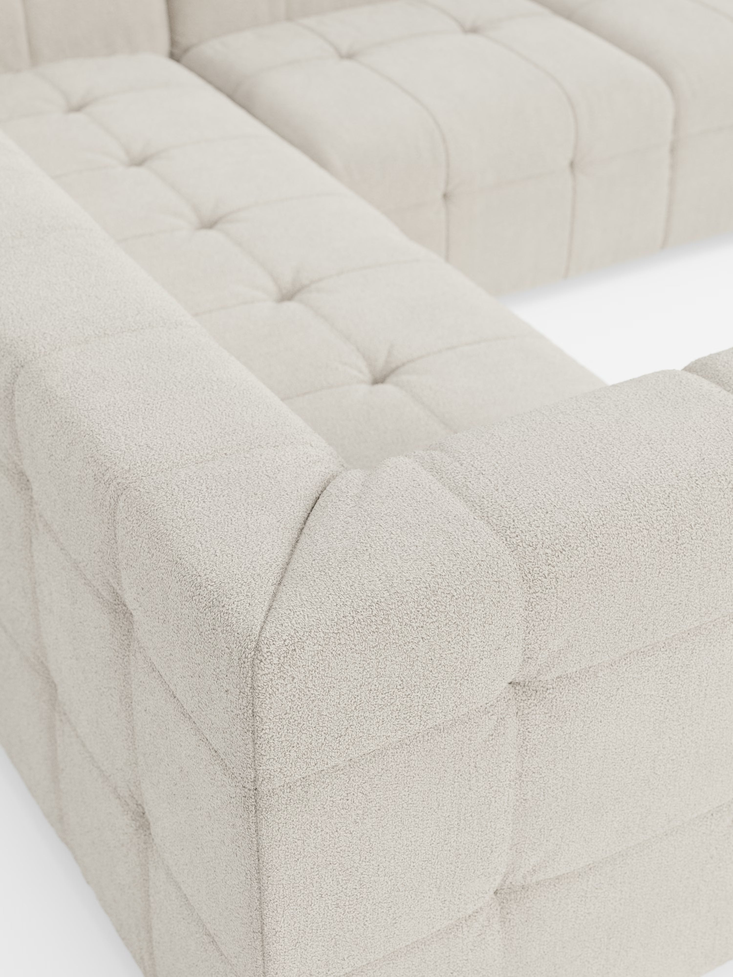 Primo piano del divano angolare componibile e modulare Mosaic in bouclé: design capitonné e tessuto antimacchia T21 di Divani.Store. Questo moderno divano componibile beige presenta un design capitonné e un tessuto morbido, dalla trama ricca e resistente alle macchie. La sua disposizione geometrica mette in risalto i cuscini quadrati con cuciture a vista, creando linee pulite e un comfort avvolgente: un elemento centrale ideale per un soggiorno moderno grazie al suo lussuoso rivestimento in bouclé.