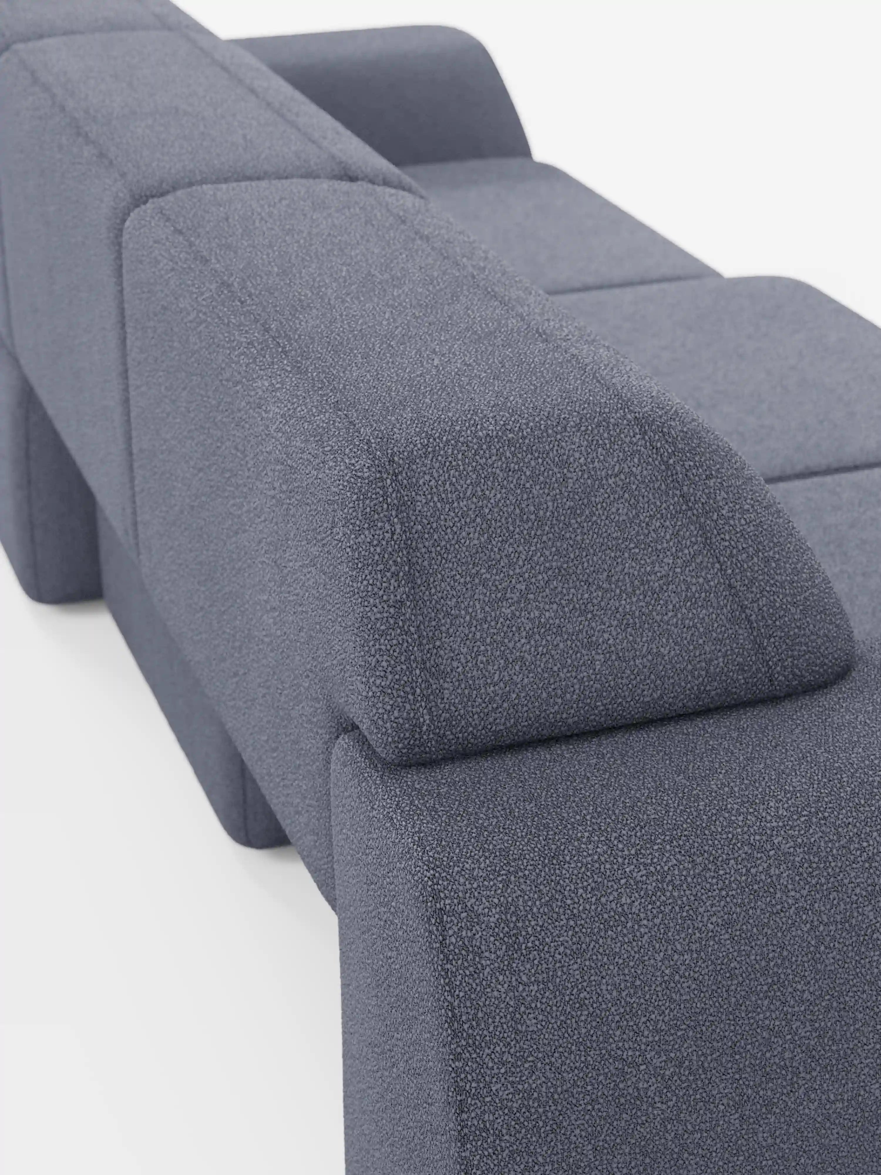 Un divano Orbit minimalista e contemporaneo in tessuto grigio, con 3 sedute scorrevoli e allungabili in tessuto effetto cotone smacchiabile T33 di Divani.Store, caratterizzato da schienali e braccioli dalla forma geometrica massiccia. Il rivestimento presenta una delicata trama in rilievo ed è completamente sfoderabile per una facile manutenzione. Ripreso da un'angolazione laterale posteriore su sfondo bianco, questo modello offre uno stile moderno unito a una funzionalità pratica.