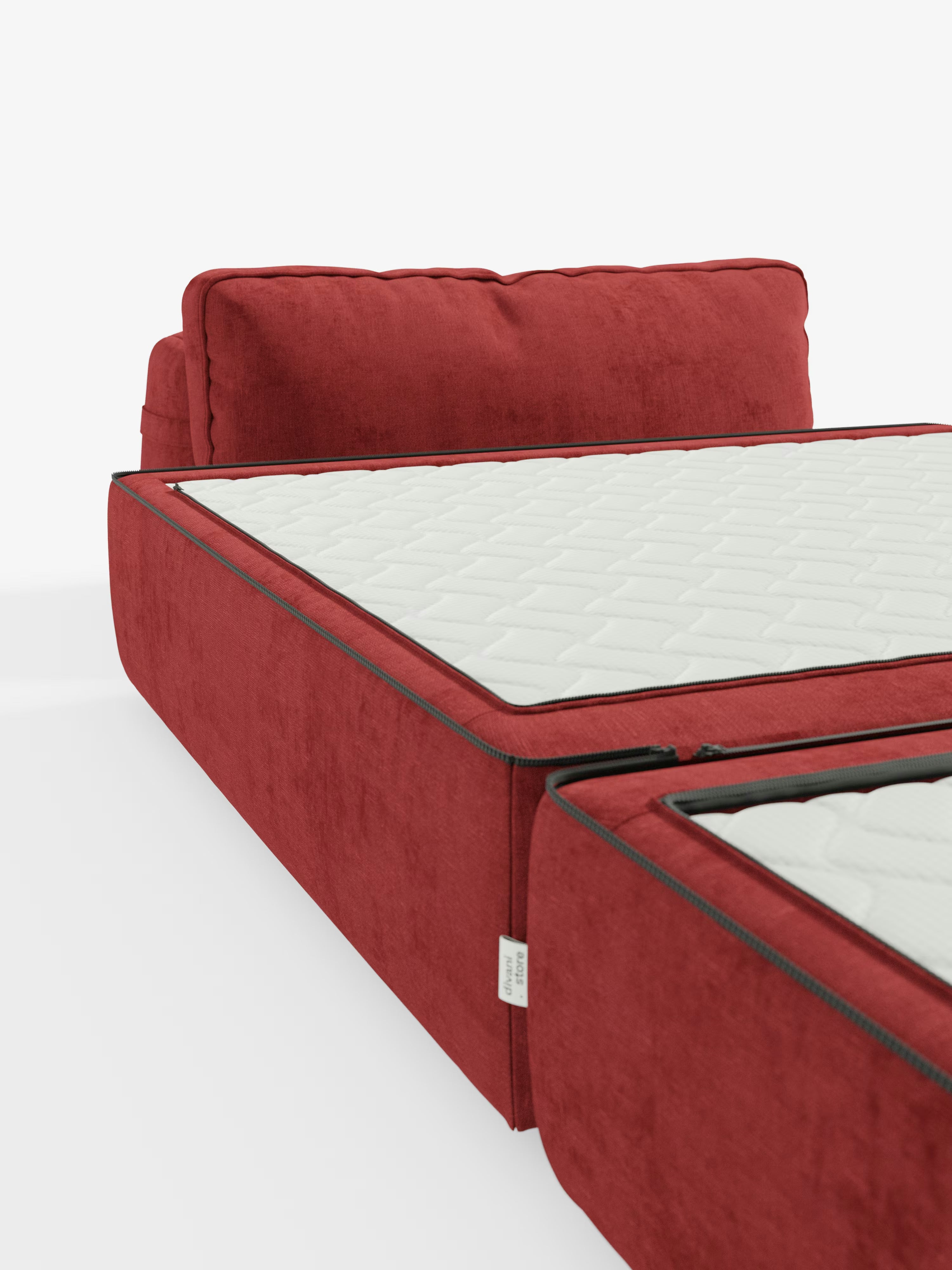 La poltrona letto Rift di Divani.Store, rivestita in rosso con tessuto T31 antimacchia, presenta morbidi cuscini dello schienale e uno schienale mobile regolabile per un comfort personalizzabile. Il materasso in memory foam, alto 24 cm, presenta cuciture a cerniera a vista che delineano le sezioni bianche trapuntate, parzialmente aperte su uno sfondo bianco per un’estetica dal design minimalista.