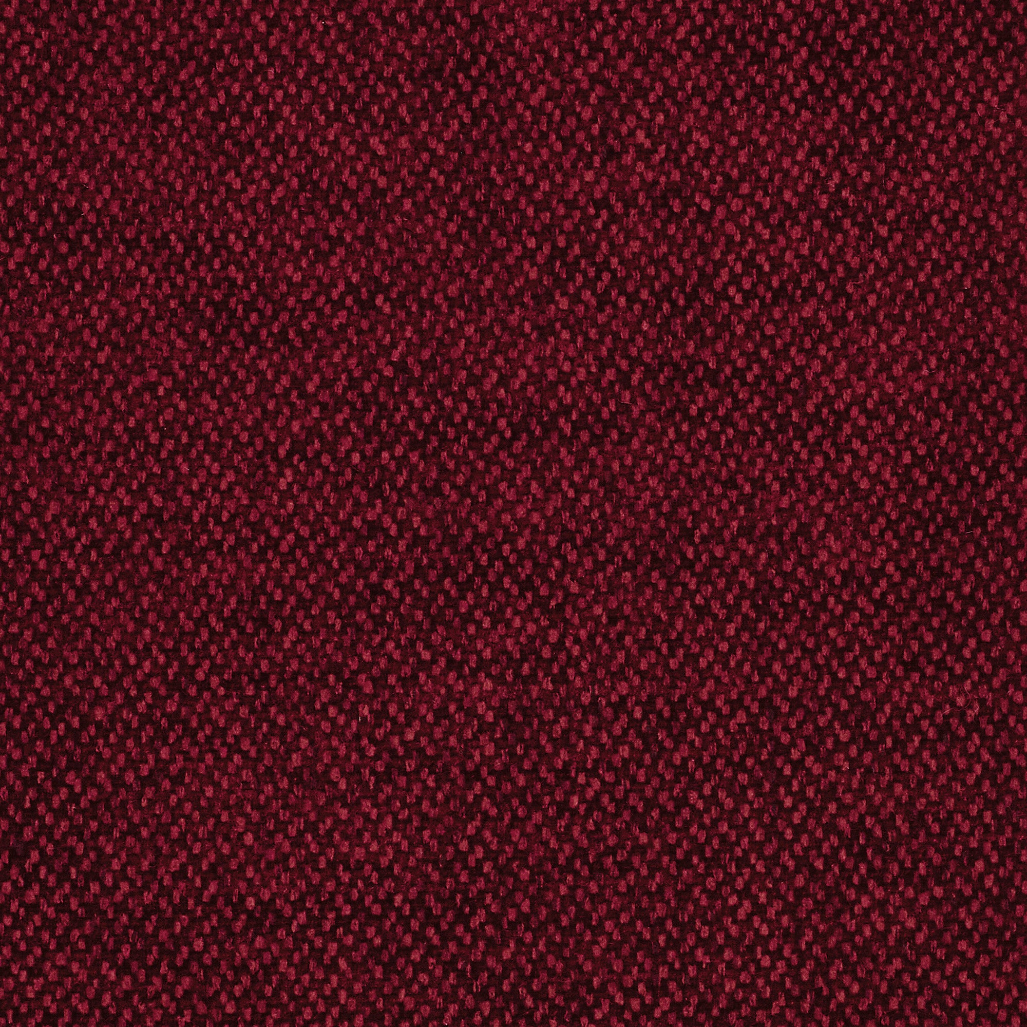 Primo piano del pouf divano modulare BonBon di Divani.Store in T23 bordeaux: un tessuto rosso scuro, resistente alle macchie, con una sottile trama a puntini e chiazze rosse più chiare che conferiscono profondità ed eleganza a questo versatile rivestimento.