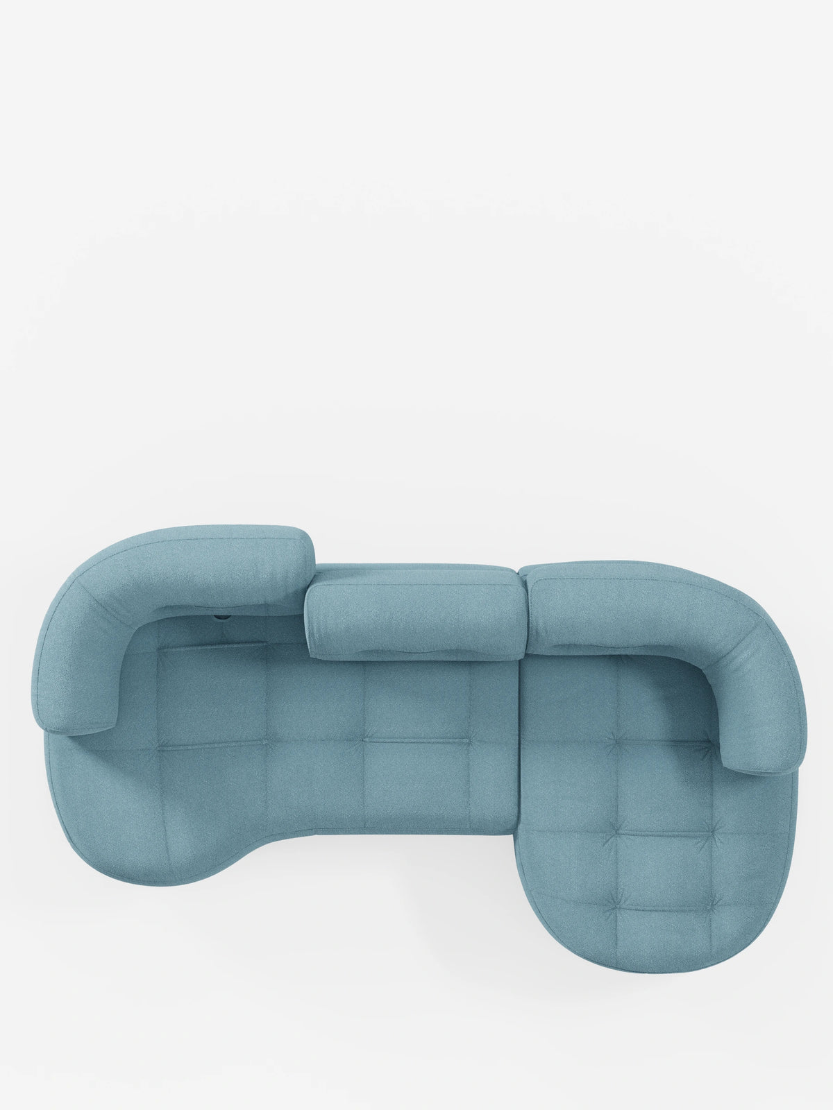 Vista dall'alto di un divano angolare “Croissant” di colore azzurro, dalla forma a fagiolo, con schienali traslanti in morbido tessuto effetto cotone smacchiabile T33, caratterizzato da un design trapuntato, bordi arrotondati e schienali centrali regolabili.