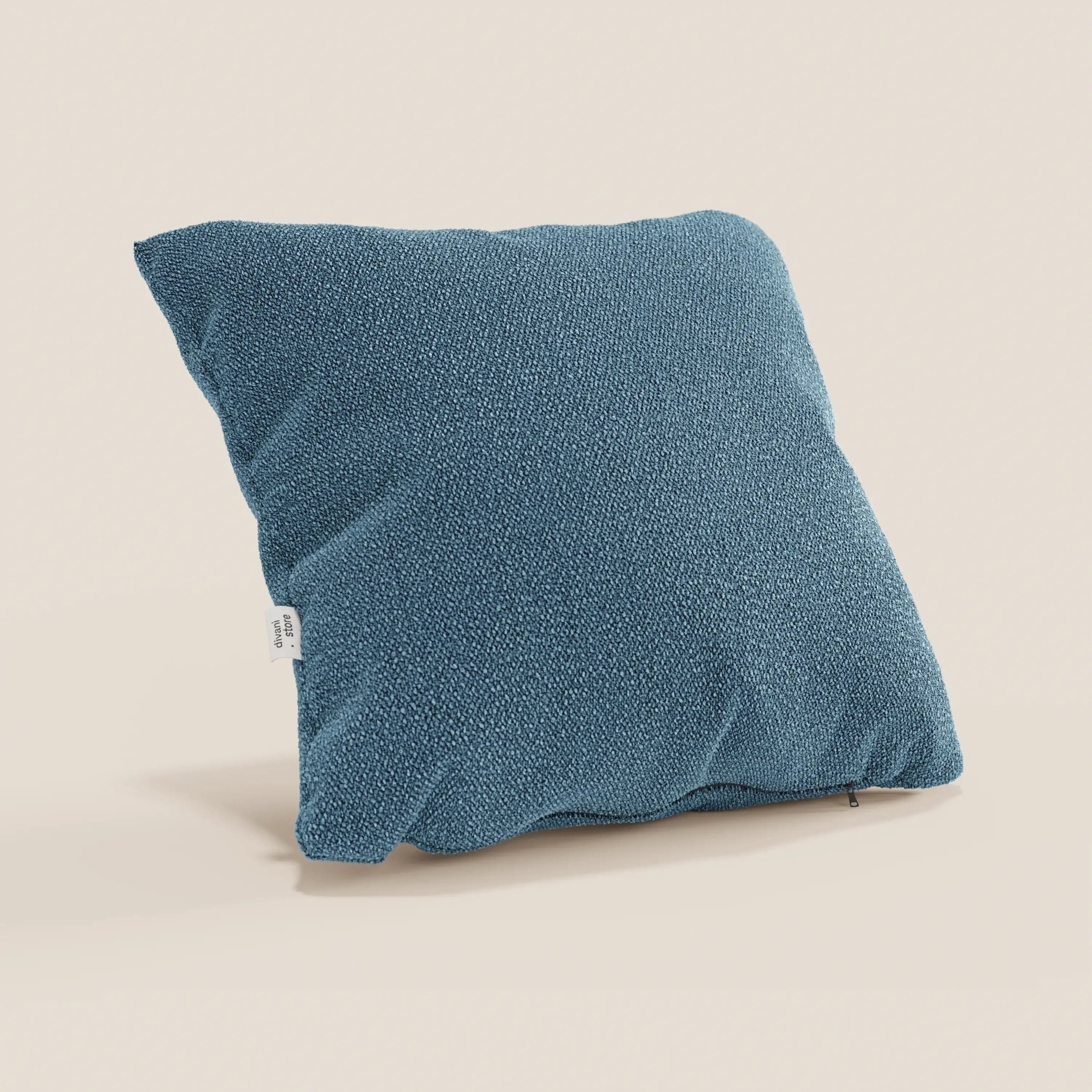 Il cuscino Lambada di Divani.Store, in blu, ha una forma quadrata, un tessuto morbido simile al cotone naturale, un'etichetta laterale bianca, una sottile cerniera sul fondo ed è resistente alle macchie e all'acqua.
