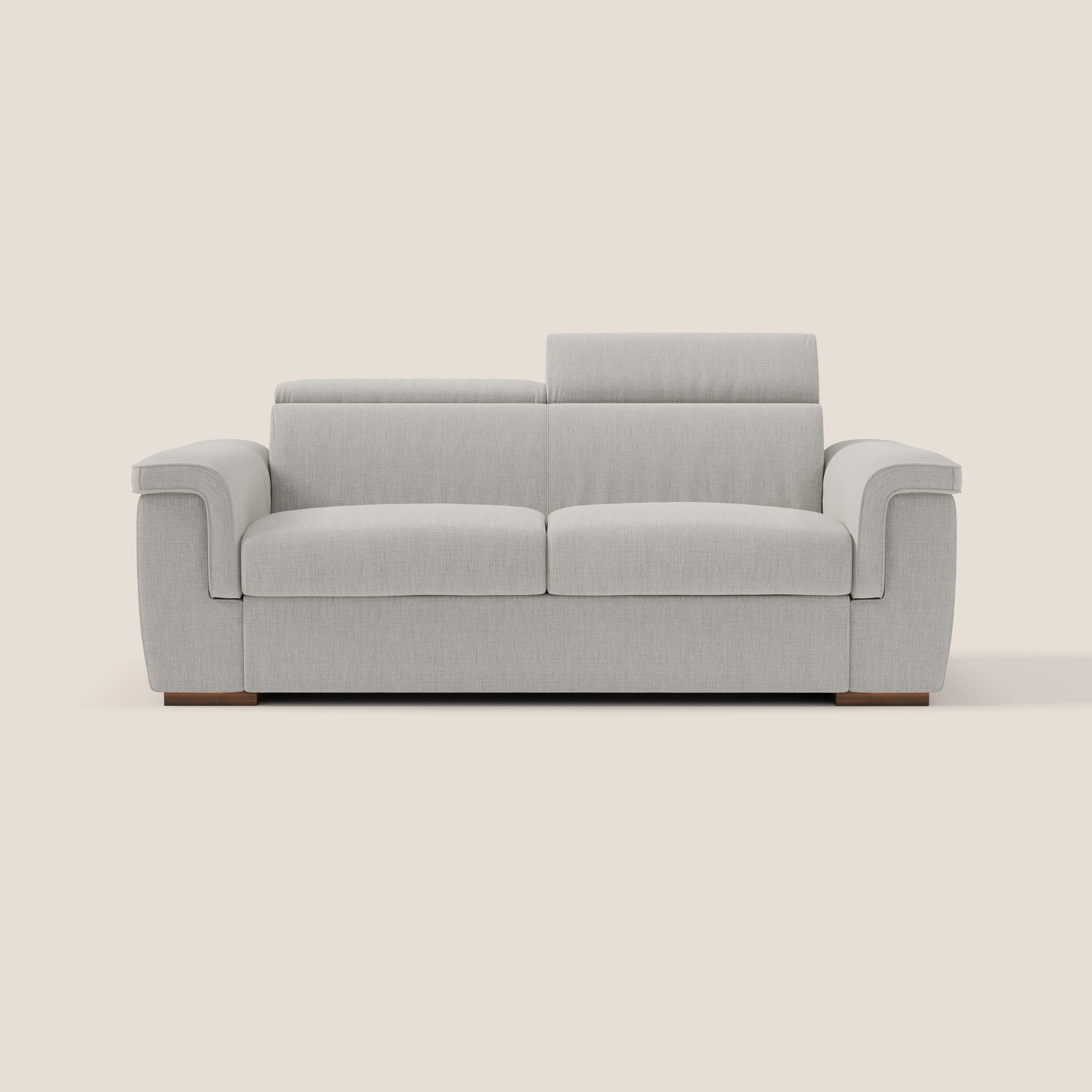 Su uno sfondo color crema, il divano letto Giunone 220 cm di Divani.Store presenta un design grigio chiaro e moderno con cuscini morbidi e un'estetica minimalista. Questo elegante pezzo offre due sedute profonde, ampi braccioli e uno schienale alto per un comfort senza pari alta densità. La sua base in legno aggiunge calore al suo fascino contemporaneo, mentre i poggiatesta reclinabili assicurano ulteriore relax.