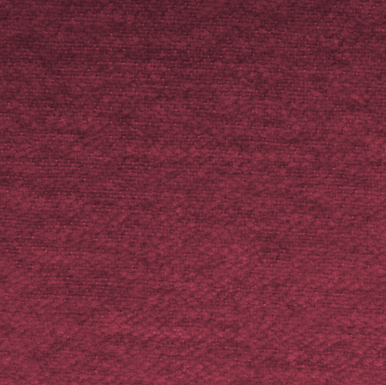 Un primo piano di T27 Brezza di Divani.Store, un tessuto goffrato morbido ed elegante di colore bordeaux intenso. Il tessuto goffrato, trattato con smacchiabile, mostra fini disegni in rilievo con una luce uniforme che ne mette in risalto la sottile trama ripetuta.