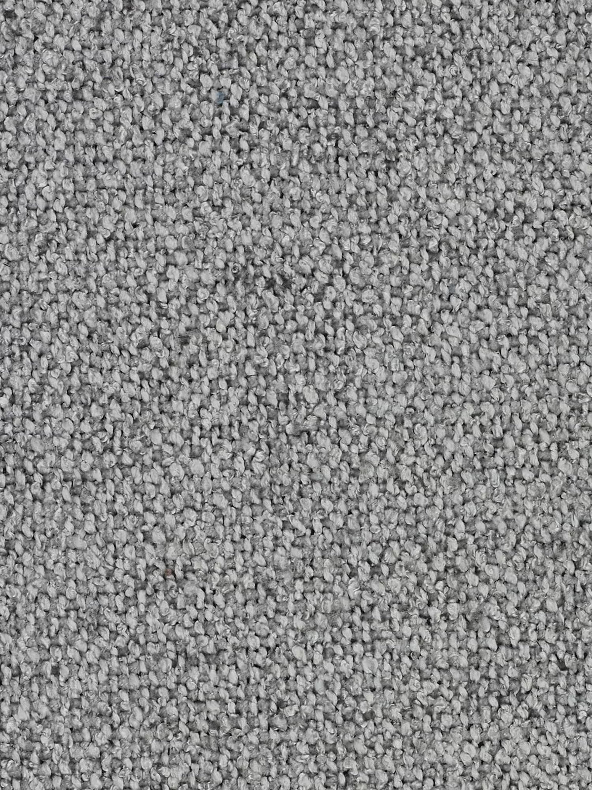 Primo piano di un tappeto grigio dalla trama ruvida, con fibre ad anello molto fitte. Il colore presenta sottili variazioni, creando un delicato effetto screziato nei toni del grigio chiaro e scuro. Questa superficie soffice e compatta trasmette comfort e resistenza: è perfetta per accompagnare il divano modulare e componibile a 3 posti Nimbus da 250 cm di Divani.Store, un divano versatile e modulare rivestito in tessuto T33 effetto cotone, sfoderabile e resistente alle macchie.