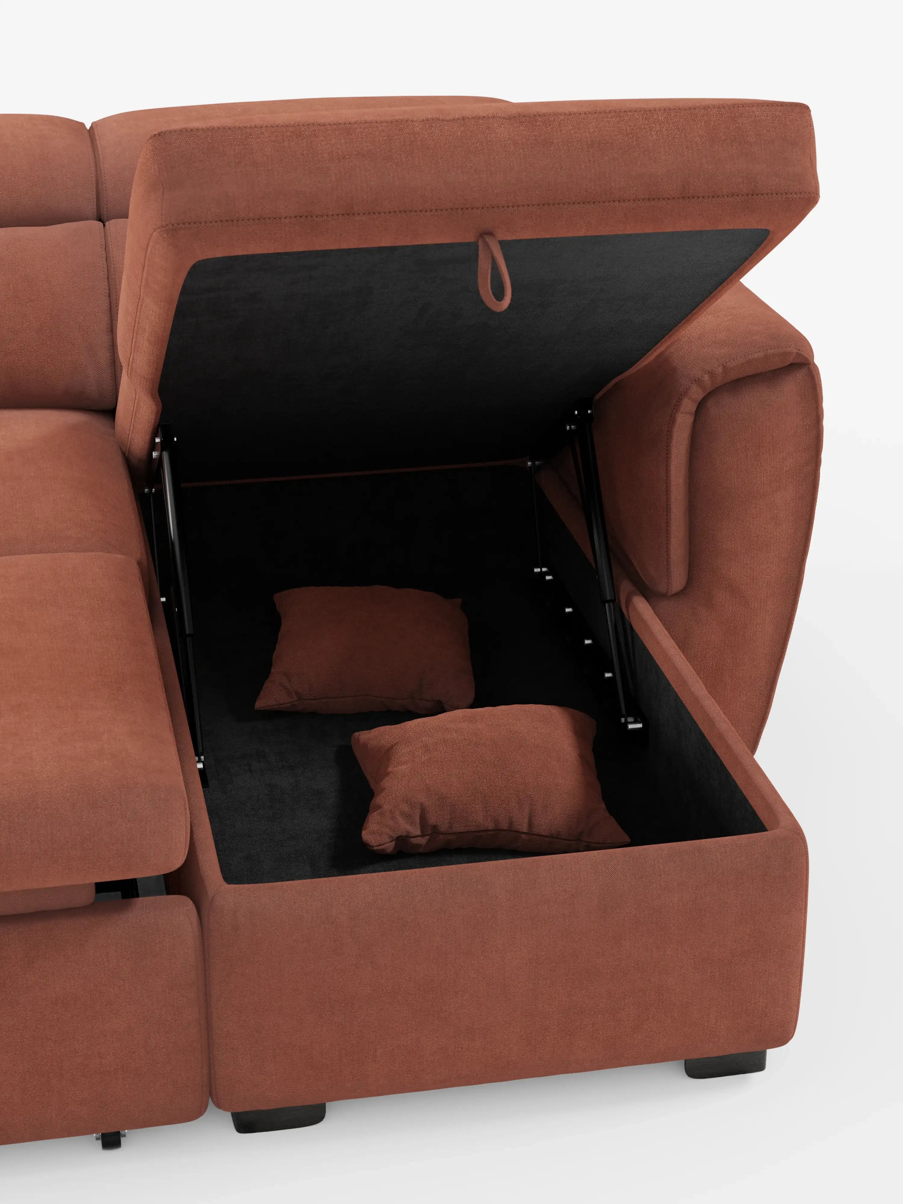 Un divano letto Titano color ruggine con penisola reversibile e contenitore di Divani.Store è raffigurato con un vano portaoggetti aperto sotto una delle sedute: il coperchio è sollevato per mostrare due cuscini decorativi coordinati all’interno. Questo divano dal design moderno presenta ampi braccioli, un morbido tessuto antimacchia, poggiatesta regolabili e una sezione estensibile, il tutto in un design squadrato e contemporaneo che risalta sullo sfondo bianco.