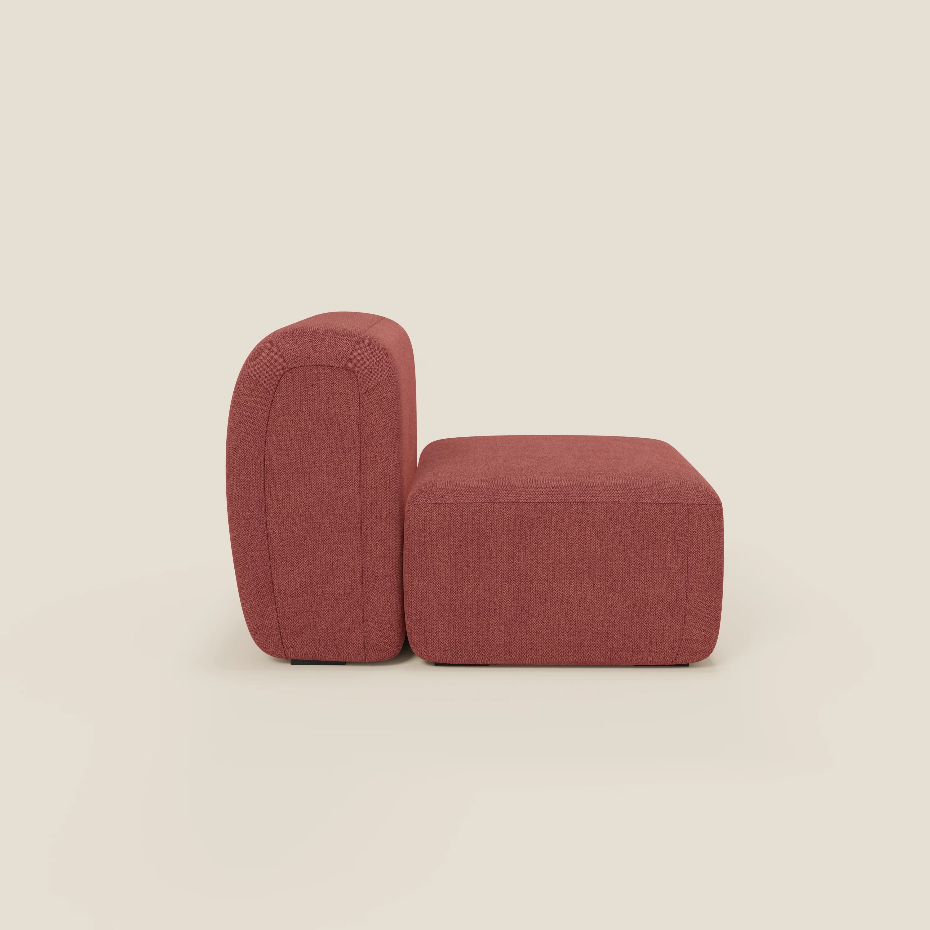 Il modulo centrale 70 cm BonBon di Divani.Store in tessuto T23 rosso ciliegia smacchiabile è presentato di profilo, con un design minimalista senza braccioli, bordi arrotondati e lisci, forma squadrata, seduta e schienale con cuscini spessi su sfondo beige.