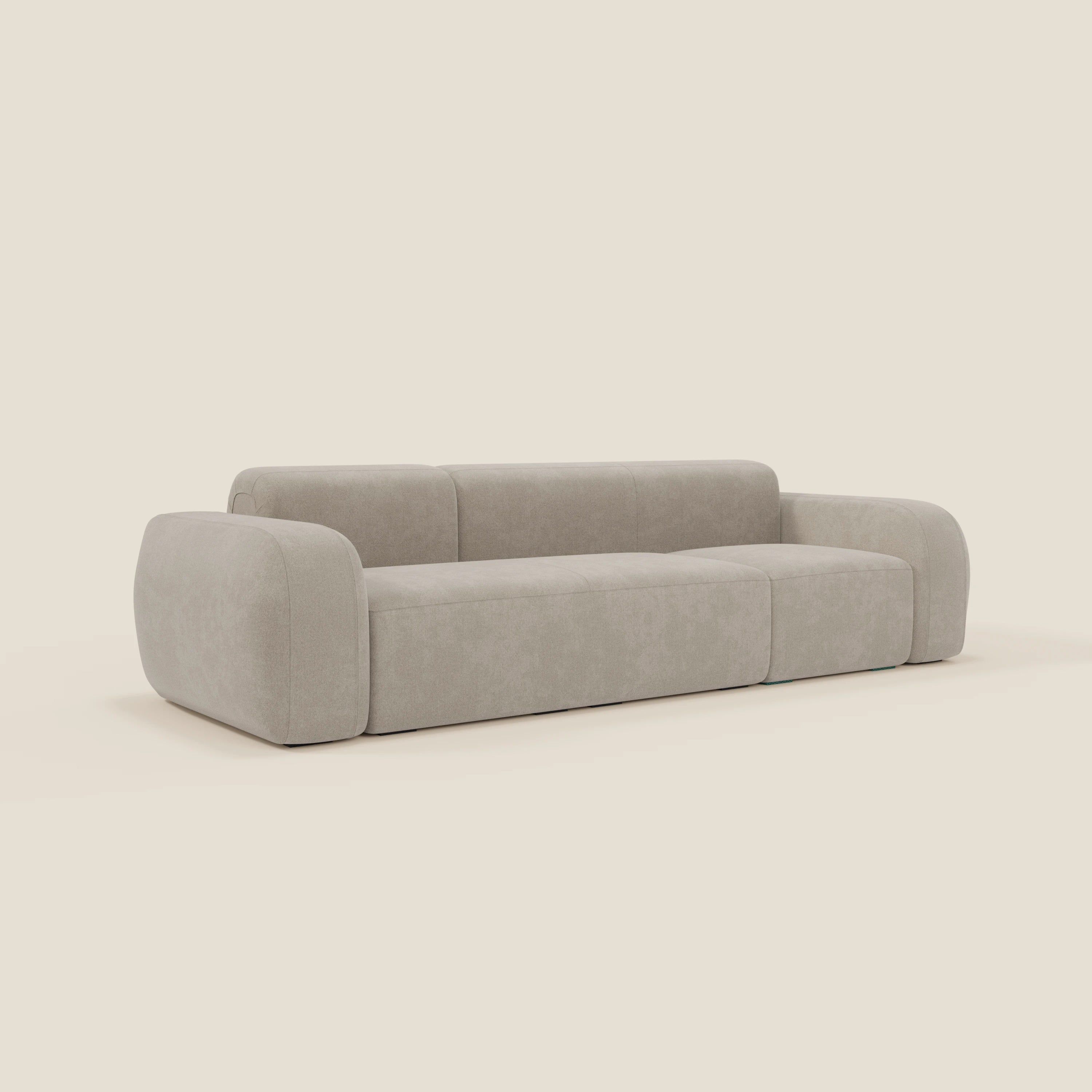 Il divano modulare componibile BonBon di Divani.Store è caratterizzato da un profilo basso e ampio con braccioli e schienale arrotondati e sovradimensionati in tessuto smacchiabile T23 panna, che sfoggia un design minimalista su uno sfondo neutro senza soluzione di continuità.