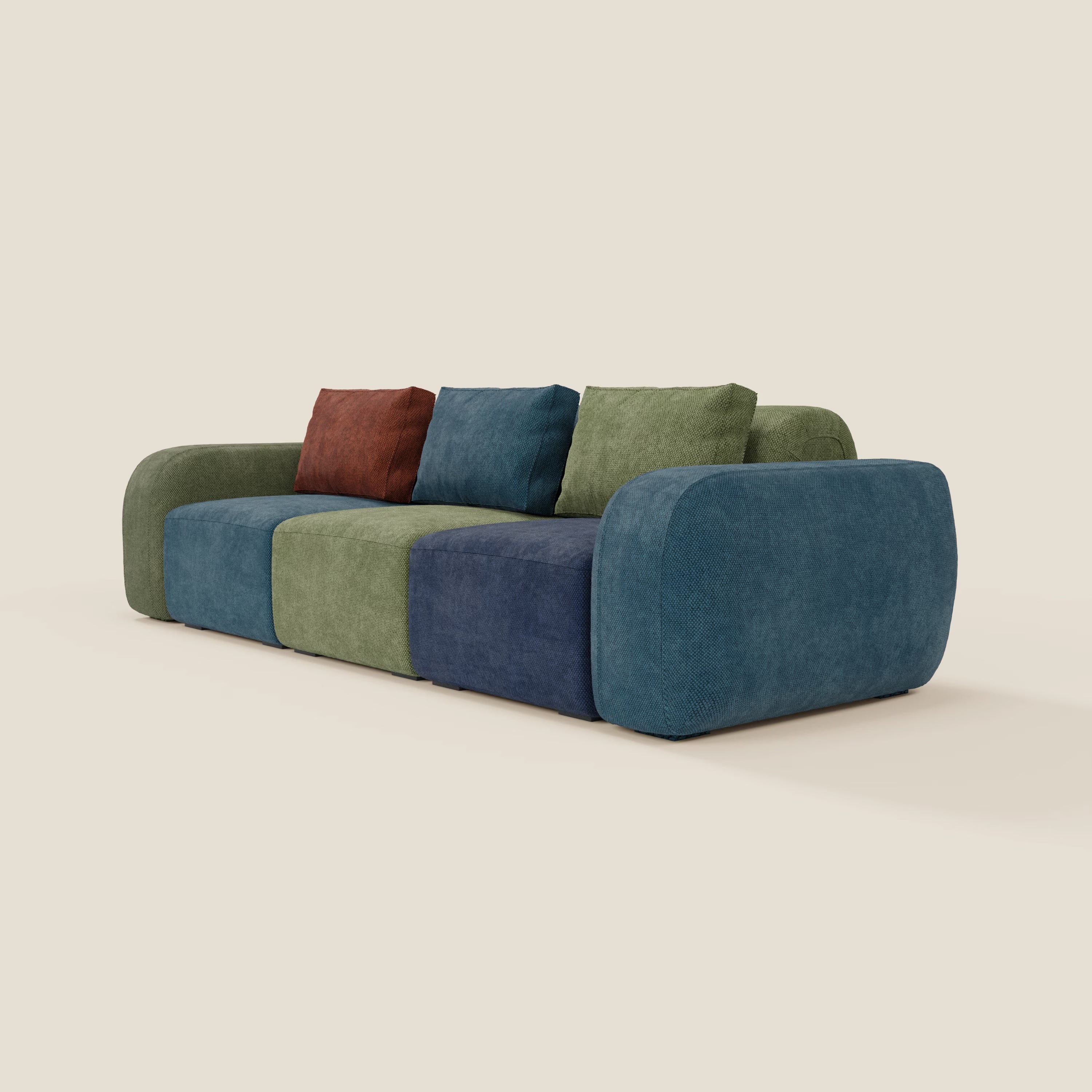 Il divano componibile 3 sedute BonBon - edizione Grande Fratello di Divani.Store è un moderno divano componibile a basso profilo con braccioli arrotondati e sezioni a blocchi di colore blu, verde e oliva, che mette in mostra il design e il comfort italiano su uno sfondo beige.