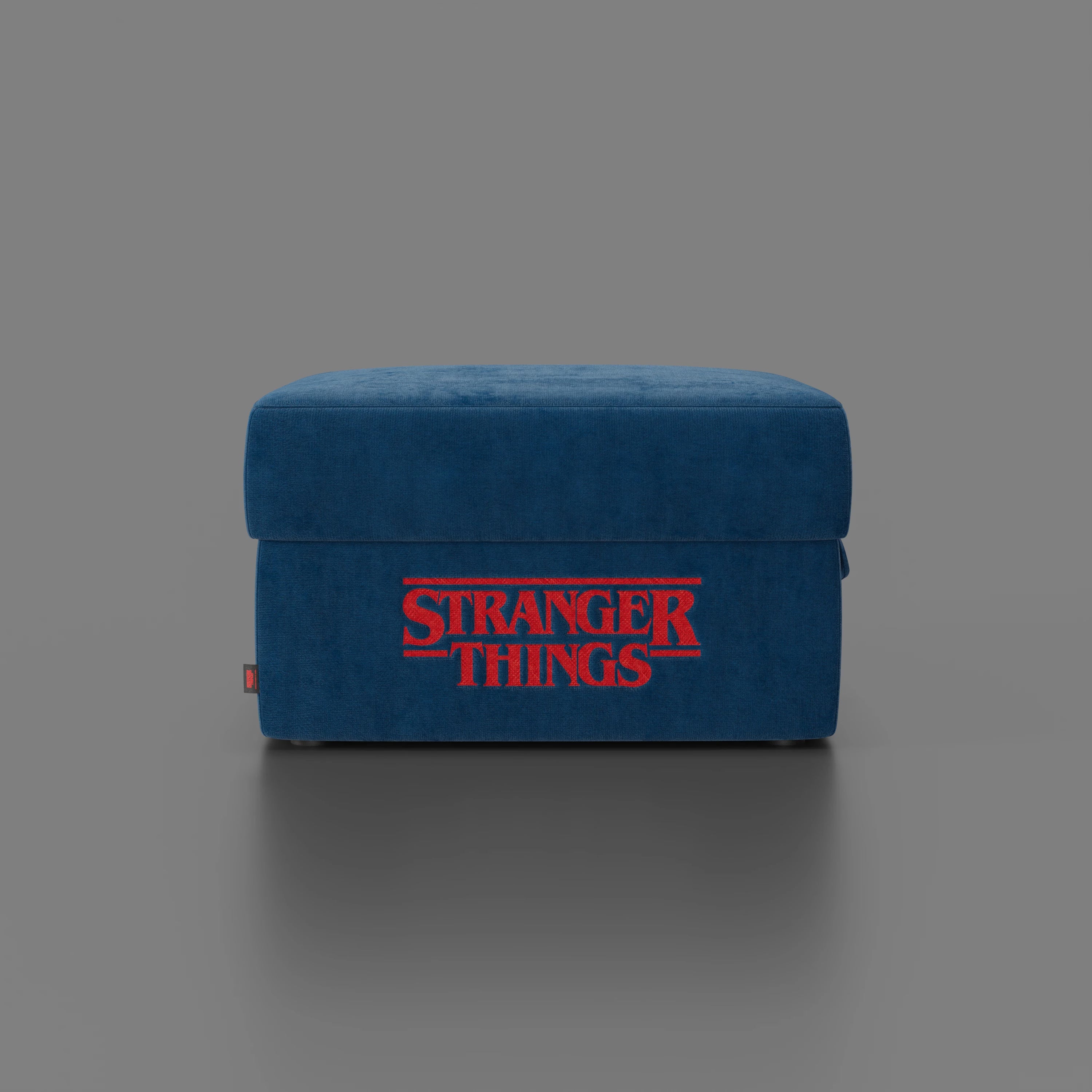 Il pouf Sun Contenitore Stranger Things Edition di Divani.Store (60x80 cm, tessuto blu antimacchia) è caratterizzato da un vistoso ricamo rosso "Stranger Things" sul davanti: un pouf imperdibile per i fan di Netflix.